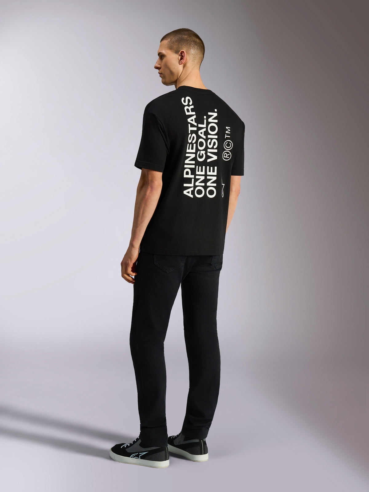 Alpinestars One Oversized CSF Tee, t-shirt de manga curta, preta, vista de costas com gráfico vertical branco 'ALPINESTARS ONE GOAL. ONE VISION.', corte oversized, streetwear casual inspirado no desporto motorizado