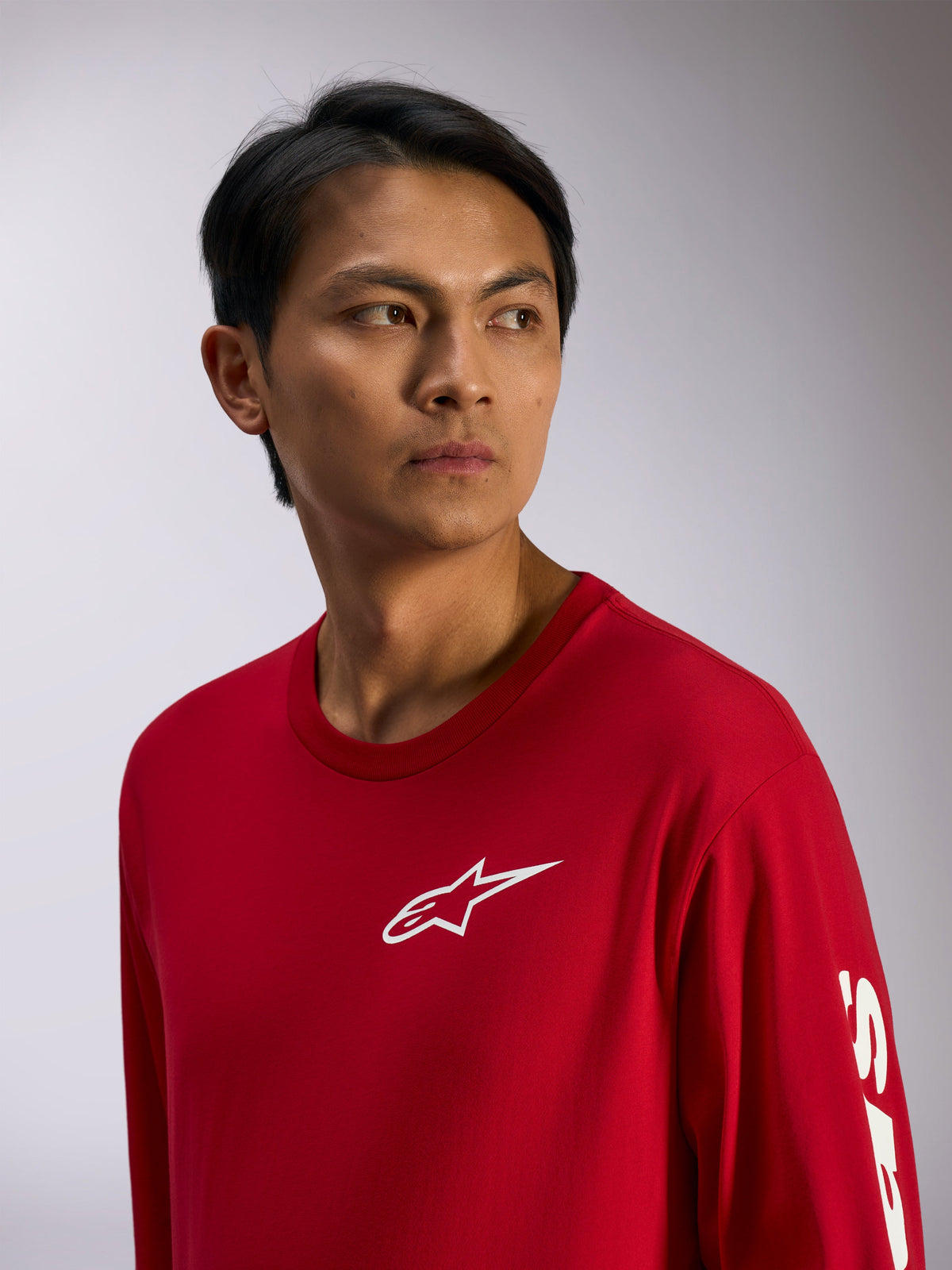 Alpinestars Trackside CSF Tee, Long Sleeve T-Shirt, Red with white Alpinestars logo on chest and lettering on sleeve, casual motorsport streetwear, lifestyle portrait