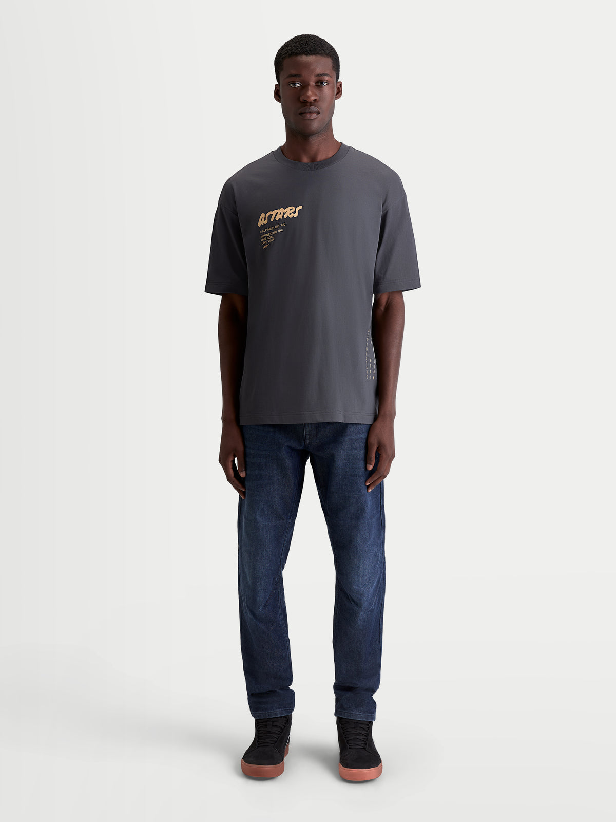 Alpinestars Chalk Oversized CSF Tee, Men's Sportswear Short Sleeve T-Shirt in Charcoal Gray with tan Astars front graphic, featuring a relaxed oversized fit and soft cotton-poly blend construction.