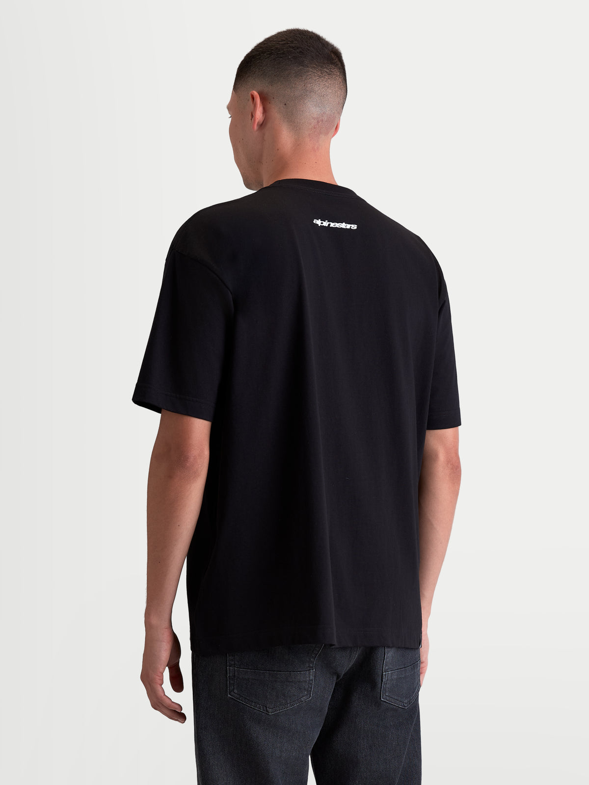 Alpinestars Prelude Oversized CSF Tee, Sportswear Short Sleeve T-Shirt, Men's Relaxed Fit, Black with white Alpinestars wordmark on the back, soft cotton-poly blend construction, rear view on model.