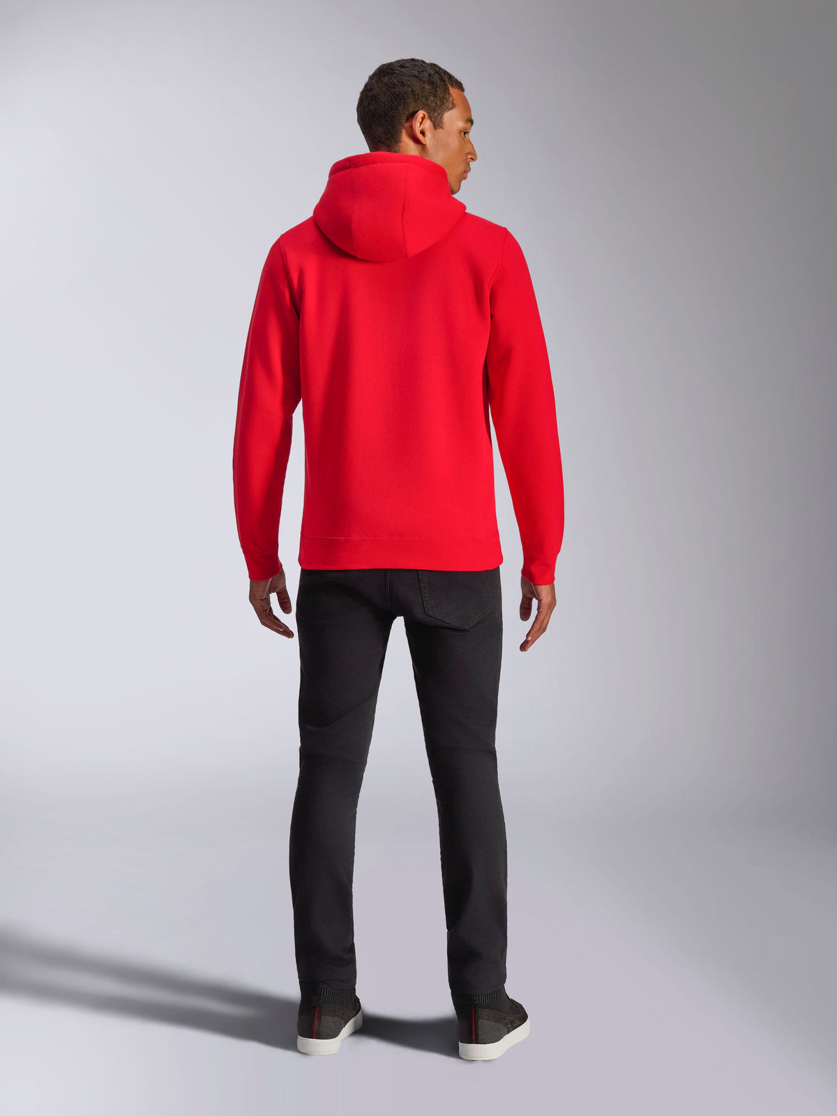 Alpinestars Ageless V3 Hoodie, back view, bright red, casual streetwear pullover, worn with black pants, modern motorsport-inspired design