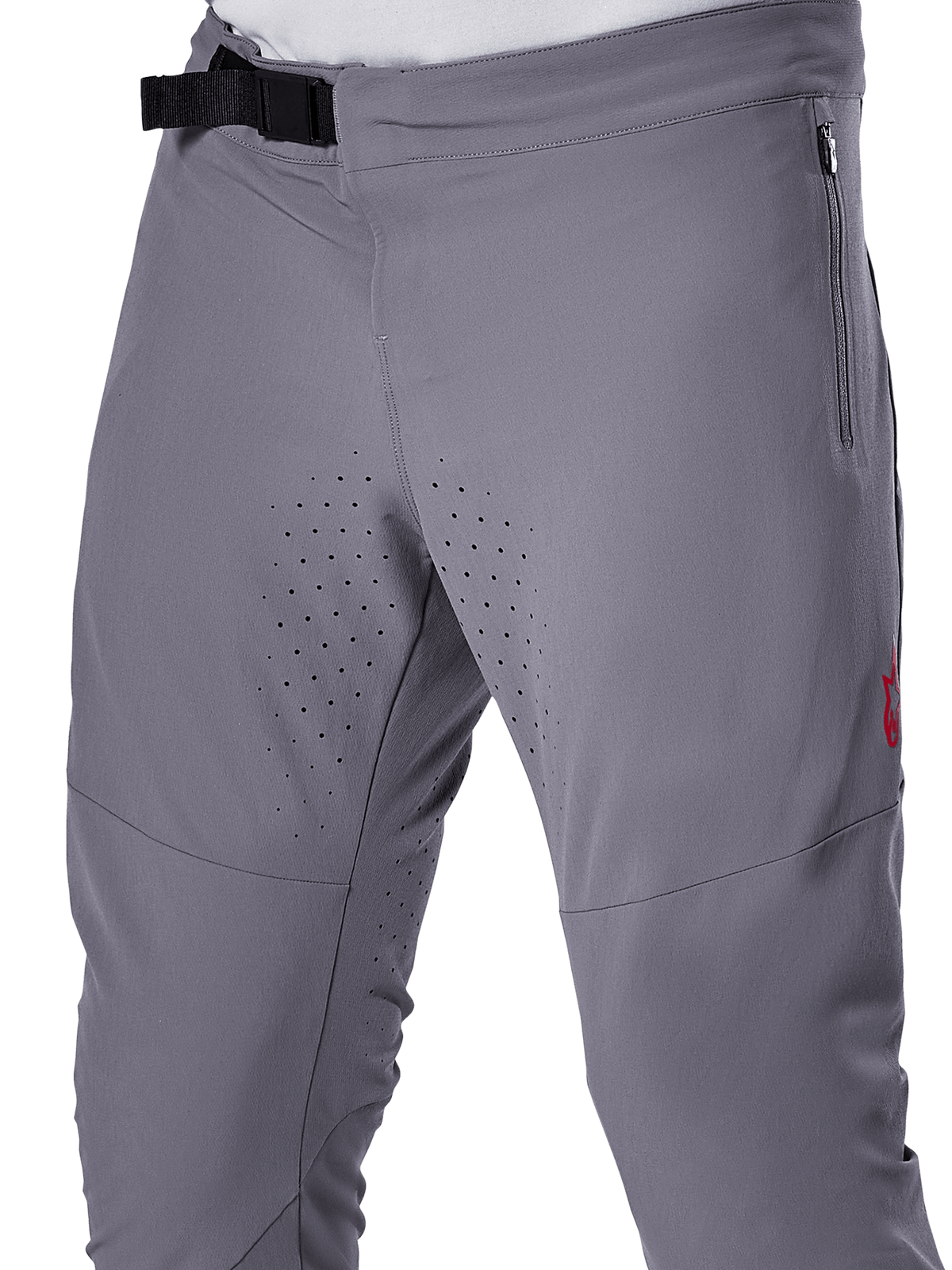 Alpinestars A-Aria Elite Pants, calças de ciclismo BTT, cinzento escuro, vista em pormenor realçando o fecho de fivela magnética, bolso lateral com fecho de correr e perfurações de ventilação a laser na parte interna das coxas para desempenho em trilhos