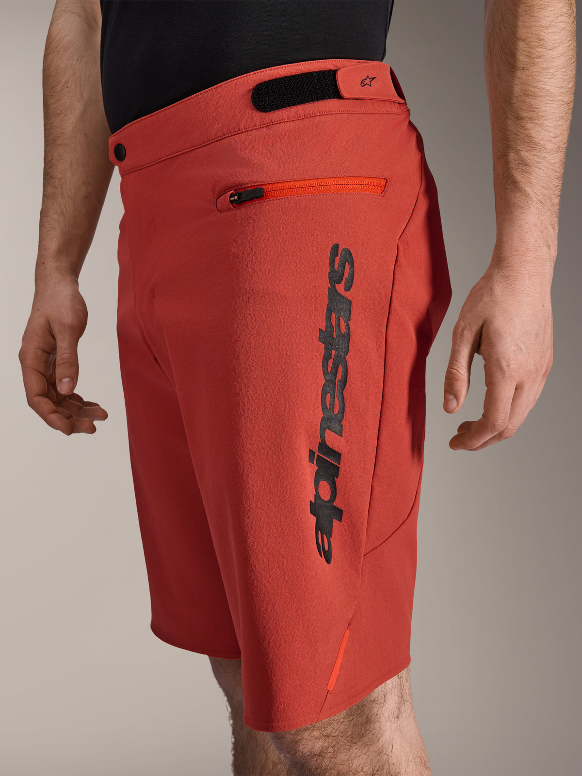 Alpinestars A-Dura Elite Shorts, Mountain Bike Shorts, Dark Orange, featuring a vertical black Alpinestars logo on the side, zippered pocket and hook-and-loop waist adjusters, durable off-road cycling apparel