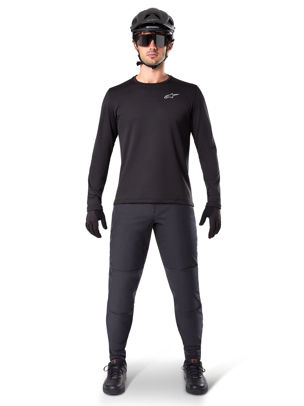 Alpinestars A-Dura Thermal Jersey, Black long-sleeve mountain bike jersey, worn with dark grey pants, black gloves, black helmet and sunglasses, featuring a white Alpinestars logo on the chest, coordinated outfit for cold-weather mountain biking
