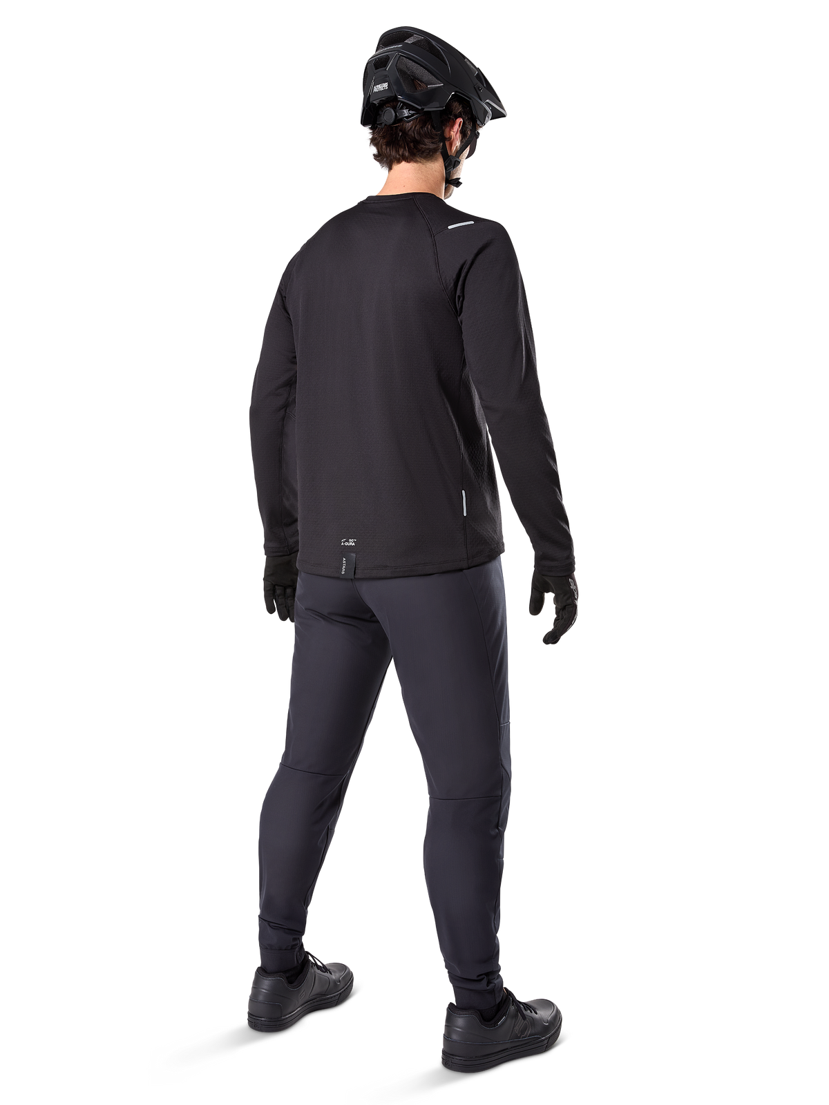 Alpinestars A-Dura Thermal Jersey, Men's Long-Sleeve Cycling Jersey, Black, rear view on model wearing a black MTB helmet, dark grey pants, and black gloves, professional mountain bike apparel for cold weather