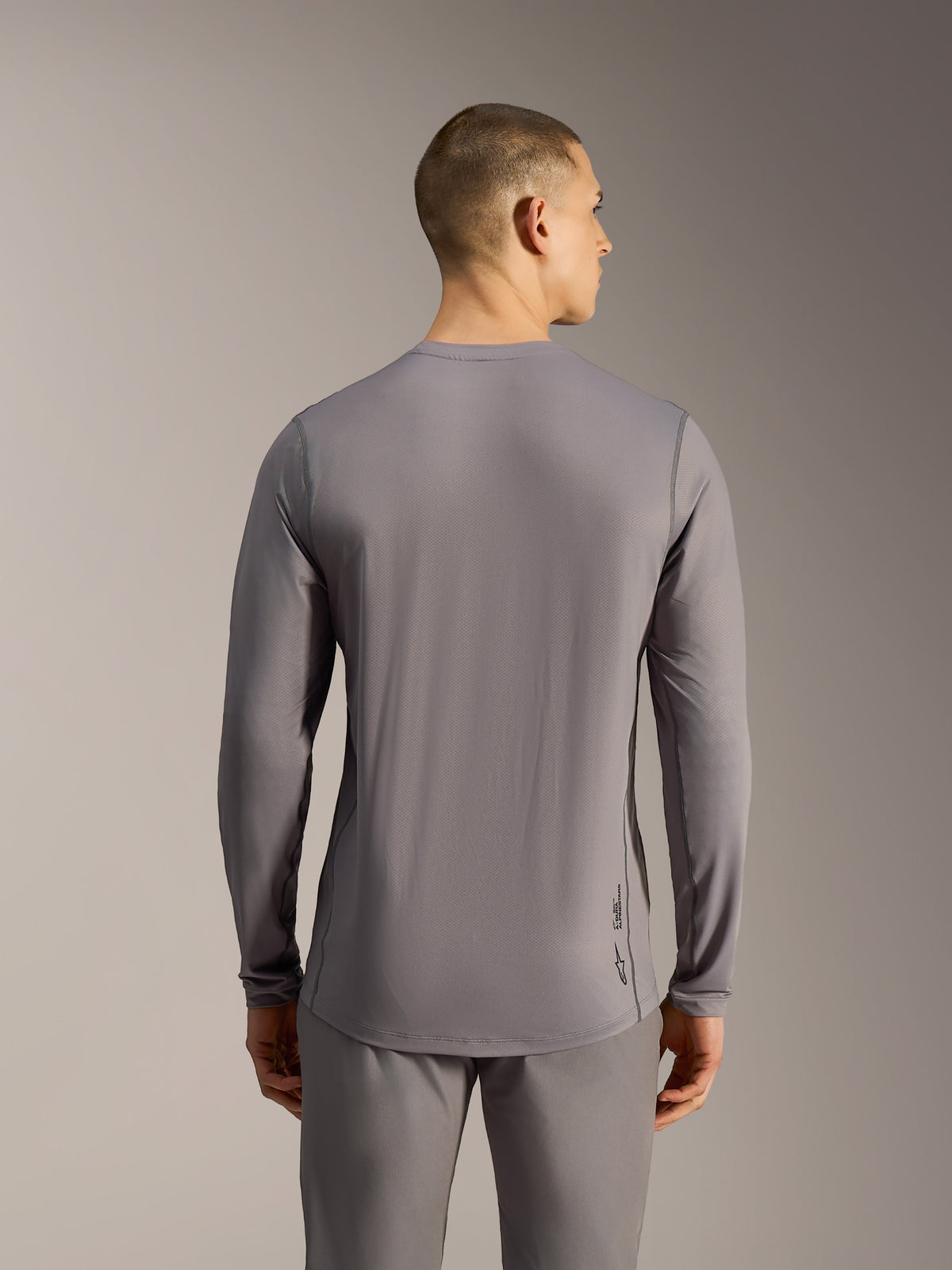 Camisola MTB Alpinestars A-Dura Ride cinzenta, manga comprida, tecido jacquard elástico e cauda mais longa.