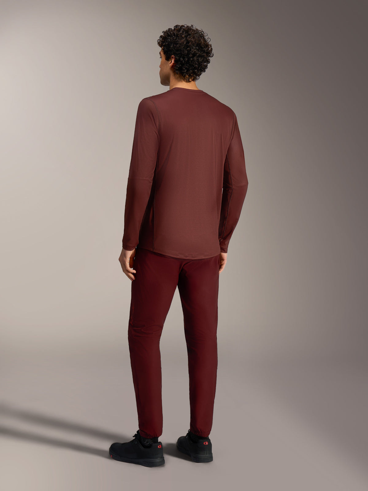 A-Dura Ride Long Sleeve Jersey in Bordeaux, rear view, breathable jacquard MTB gear with an extended drop tail design.