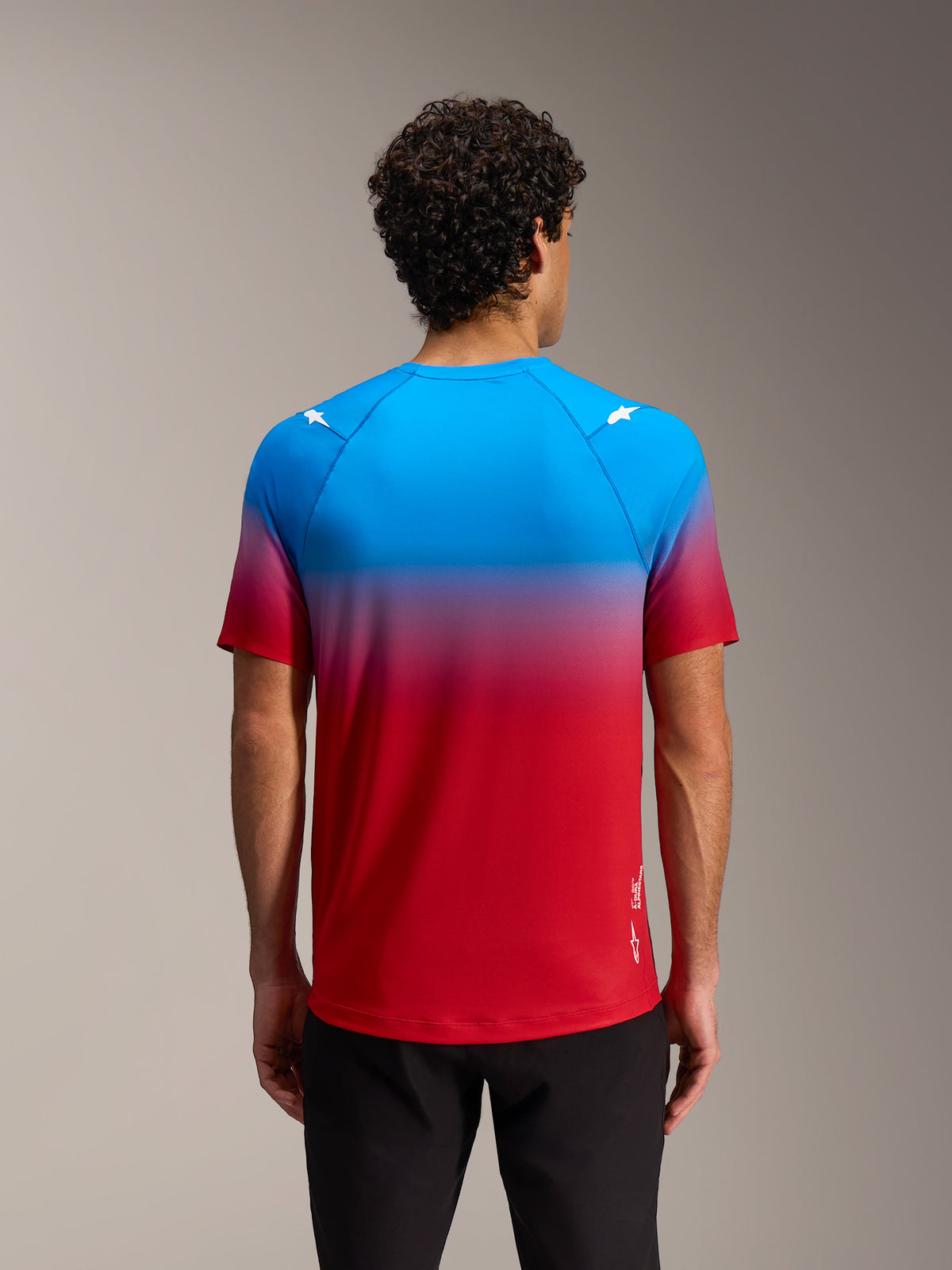 Alpinestars A-Dura ASTARS 2.0 Short Sleeve Jersey in Bright Red Blue gradient with shoulder star logos, back view.