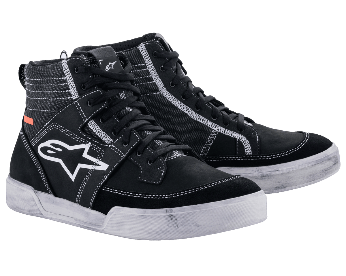 Alpinestars Ageless Riding Shoes, Urban Motorcycle Footwear, Black with white contrast stitching and soles, high-top sneaker silhouette featuring a large white star logo on the side, casual protective gear for road riding