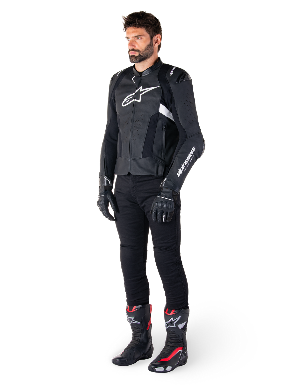 Alpinestars Missile V3 Airflow Leather Jacket, Black and White, worn by a male model with black riding pants, black gloves, and racing boots with red and white accents, featuring perforated leather and white logo branding, performance motorcycle racing gear