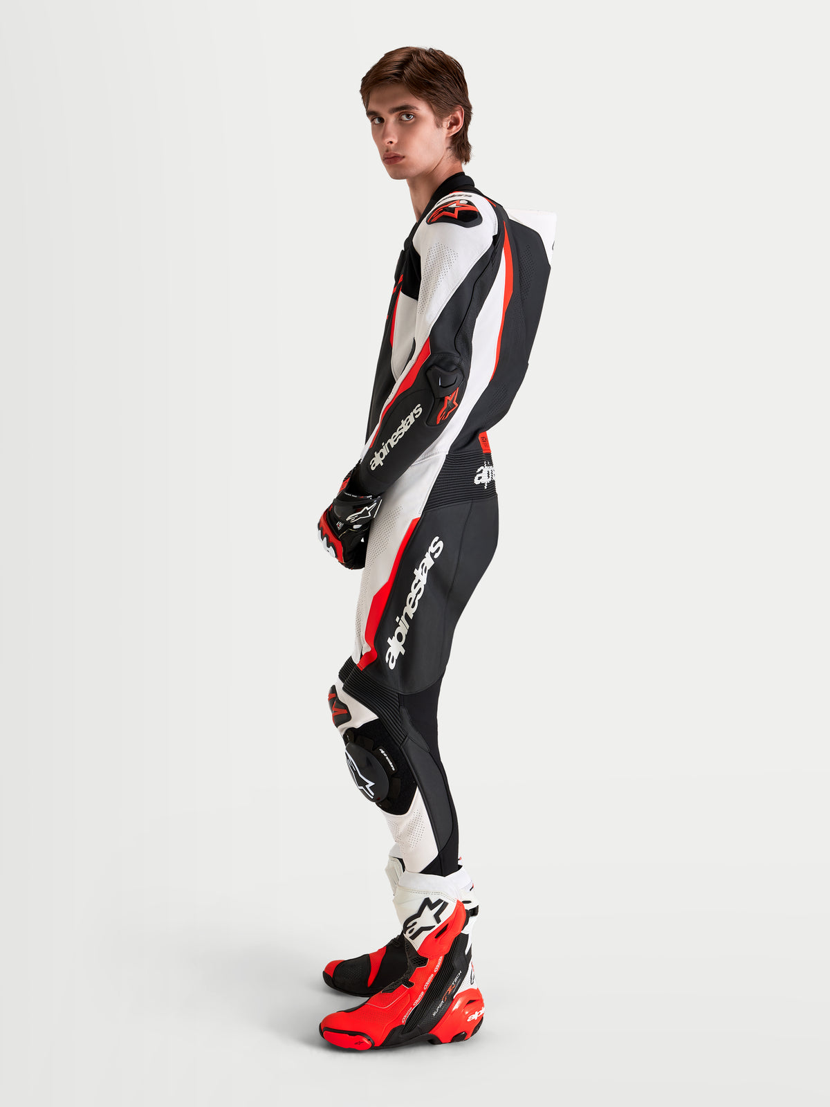 Alpinestars Missile V3 Leather Suit 1 Piece, men's motorcycle racing suit, Black White and Red Fluo, featuring DFS armor, aerodynamic speed hump, and premium leather construction, shown on model