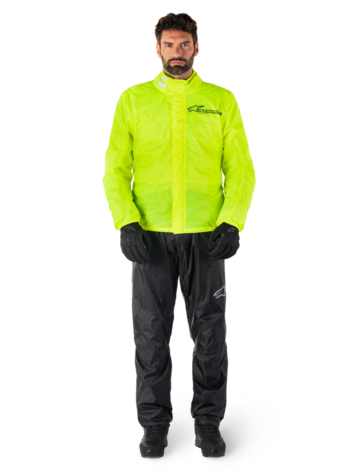 Alpinestars Hurricane Rain V2 Jacket and Pants, Neon Yellow and Black, waterproof motorcycle rain suit worn with black gloves and boots, featuring the Alpinestars logo on the chest and leg