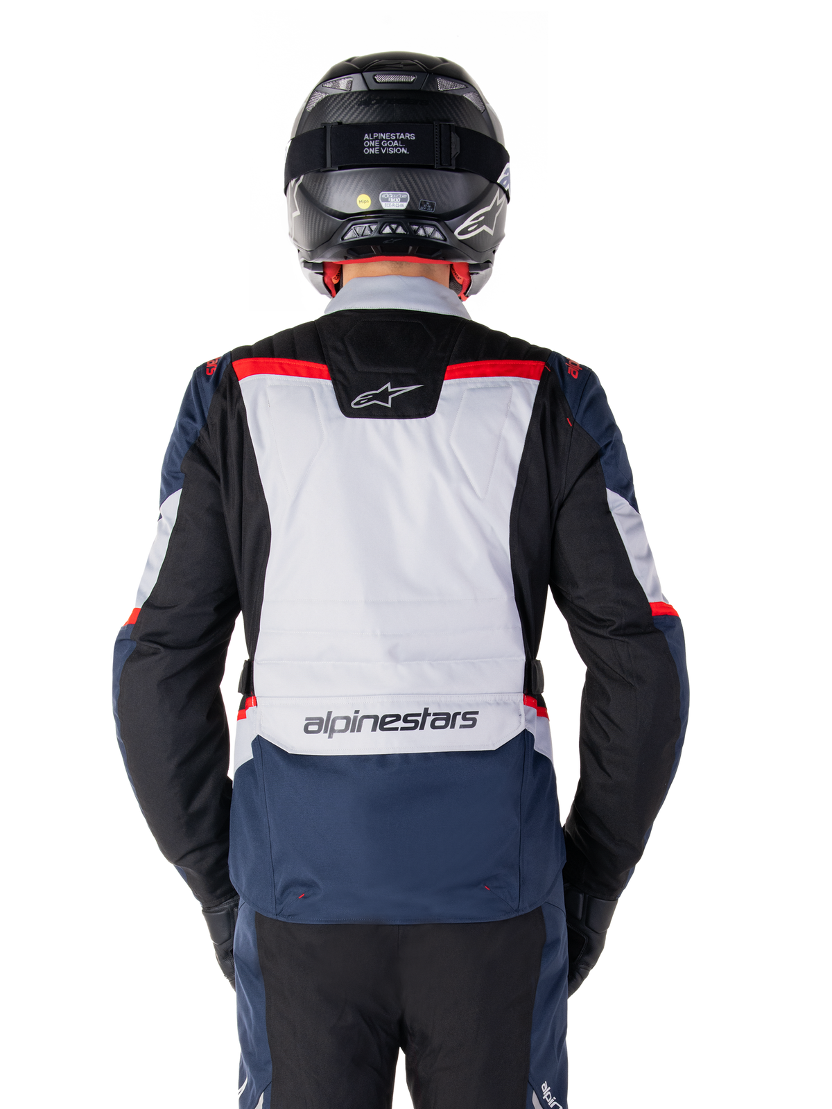 Alpinestars ST-1 Waterproof Jacket, Dark Blue Black and Bright Red, rear view showing light gray back panel and branding, adventure touring motorcycle jacket worn with black helmet and gloves, streamlined design for all-weather riding