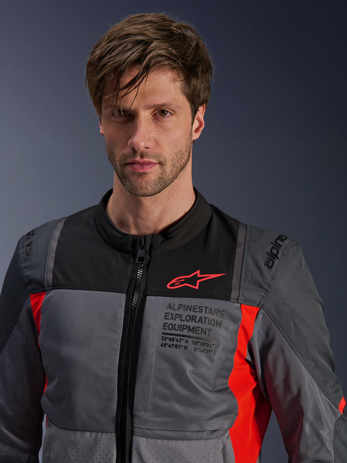 Alpinestars ST-2 Air Jacket, Men's Gray and Red Textile Touring Jacket with mesh ventilation, worn by a model.