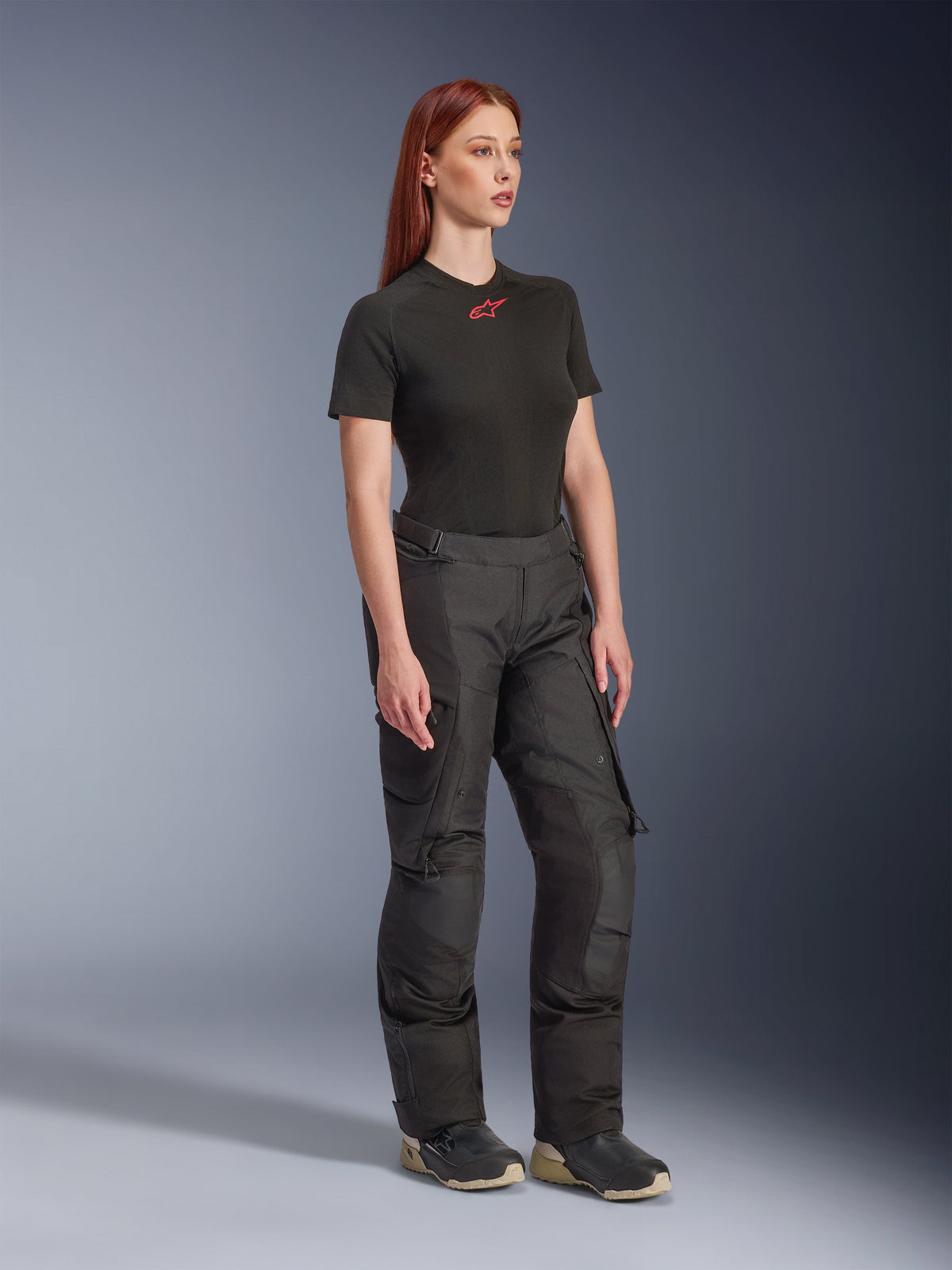 Alpinestars Stella Andes V4 Drystar® Pants, Women's Motorcycle Pants, Black, worn with a black short-sleeve t-shirt with a red logo and technical shoes, adventure touring design with reinforced panels and ventilation zips, full-length three-quarter view