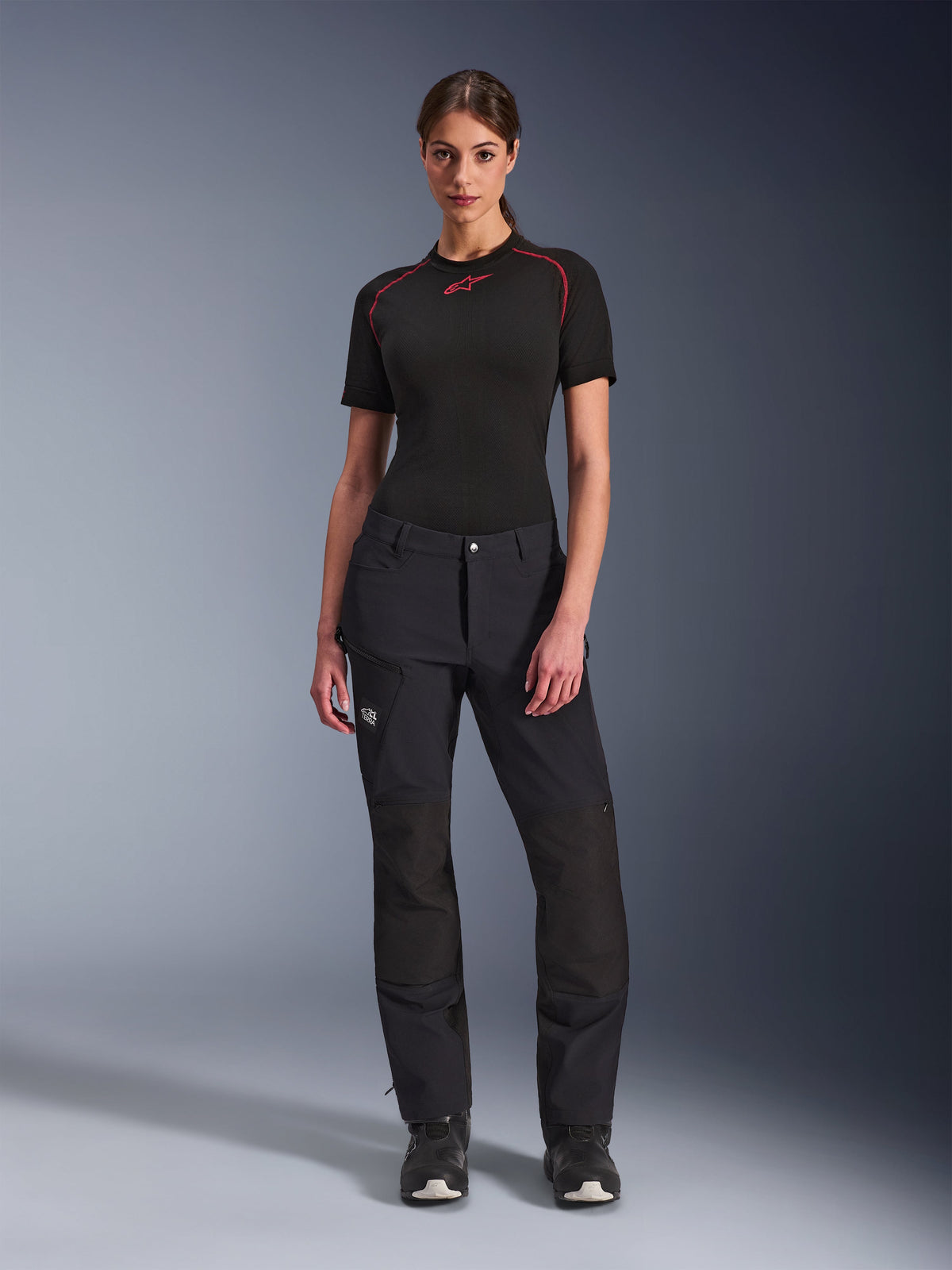 Alpinestars Stella Flex-AST Explorer Pants, Women's Adventure Riding Pants, Black, worn with a black Alpinestars base layer and boots, featuring reinforced ripstop knee panels and breathable stretch textile construction.