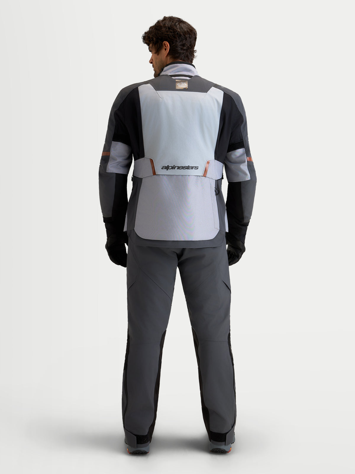 Alpinestars St-7 V2 2L Gore-Tex® Gear Set, men's adventure touring motorcycle jacket and pants in mid gray, deep gray, and black, rear view on a model wearing matching gear, waterproof textile construction