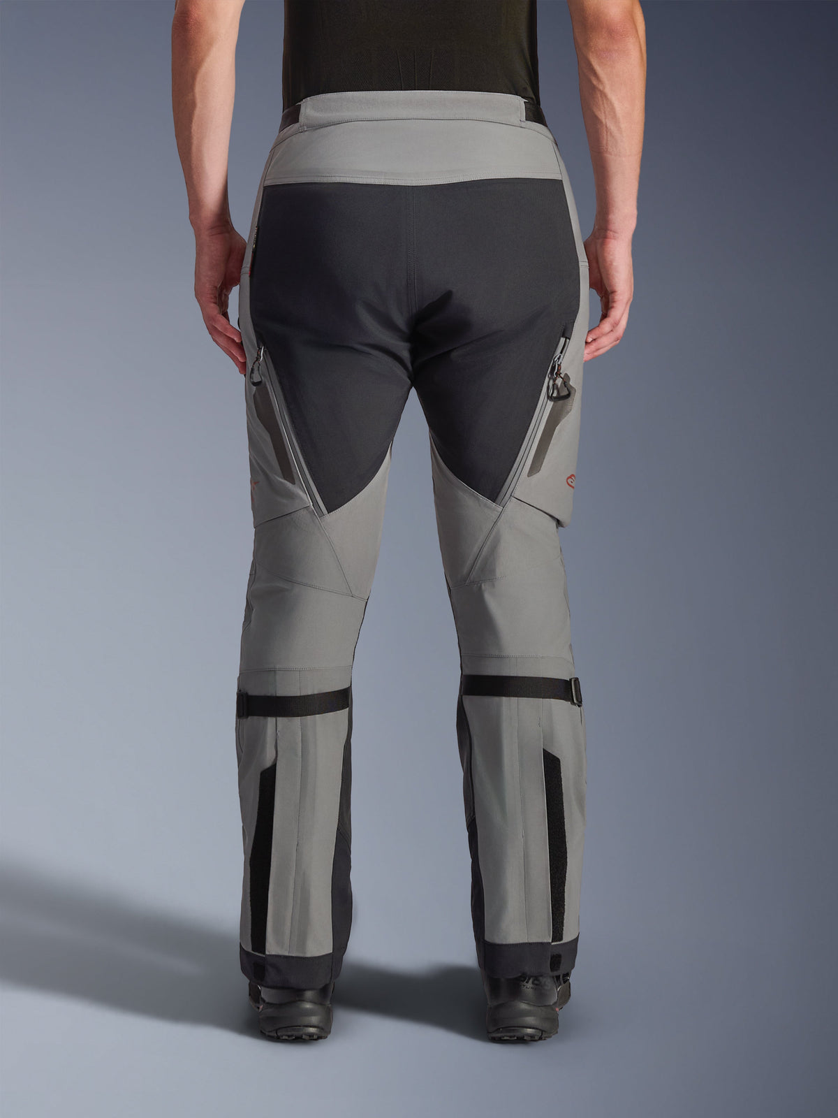 Alpinestars Nazca 3L GORE-TEX PRO Pants, Adventure Motorcycle Pants, Dark Gray and Black, back view, featuring zippered exhaust vents on thighs, calf volume adjusters, and reinforced seat panels, designed for extreme all-terrain riding.