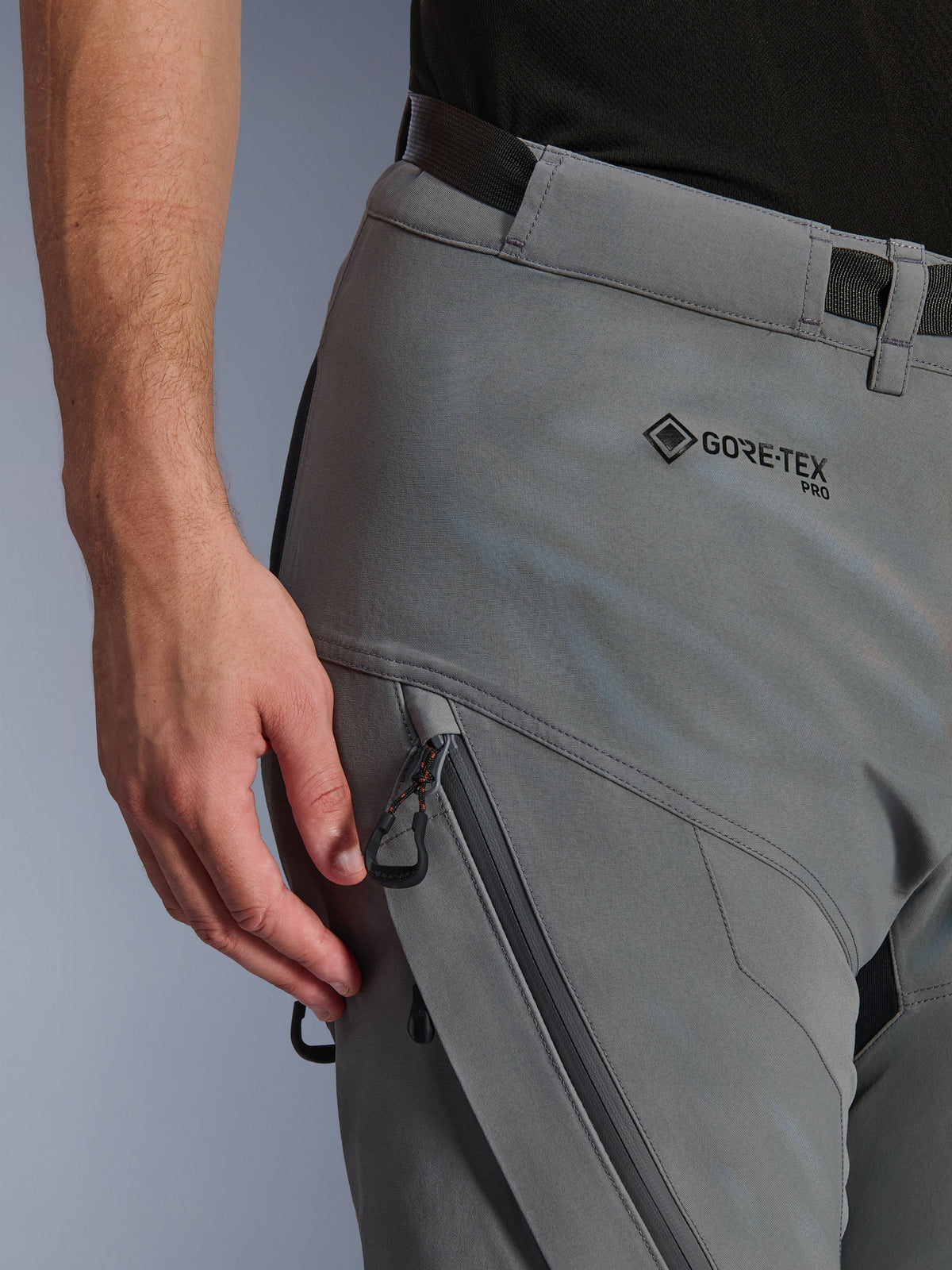 Close-up of Alpinestars Nazca 3L GORE-TEX PRO Pants in Dark Gray Black, showing the GORE-TEX PRO branding on the hip, a zippered water-resistant cargo pocket, and durable textile construction for adventure riding.