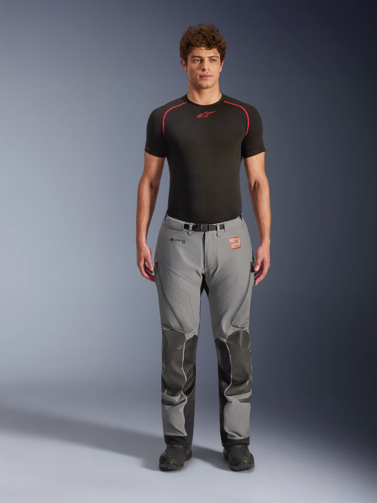 Alpinestars Nazca 3L GORE-TEX PRO Pants, Adventure Motorcycle Pants, Gray and Black, worn by model with a black base layer, featuring reinforced knee panels, GORE-TEX PRO branding, and a rugged textile design for all-weather touring