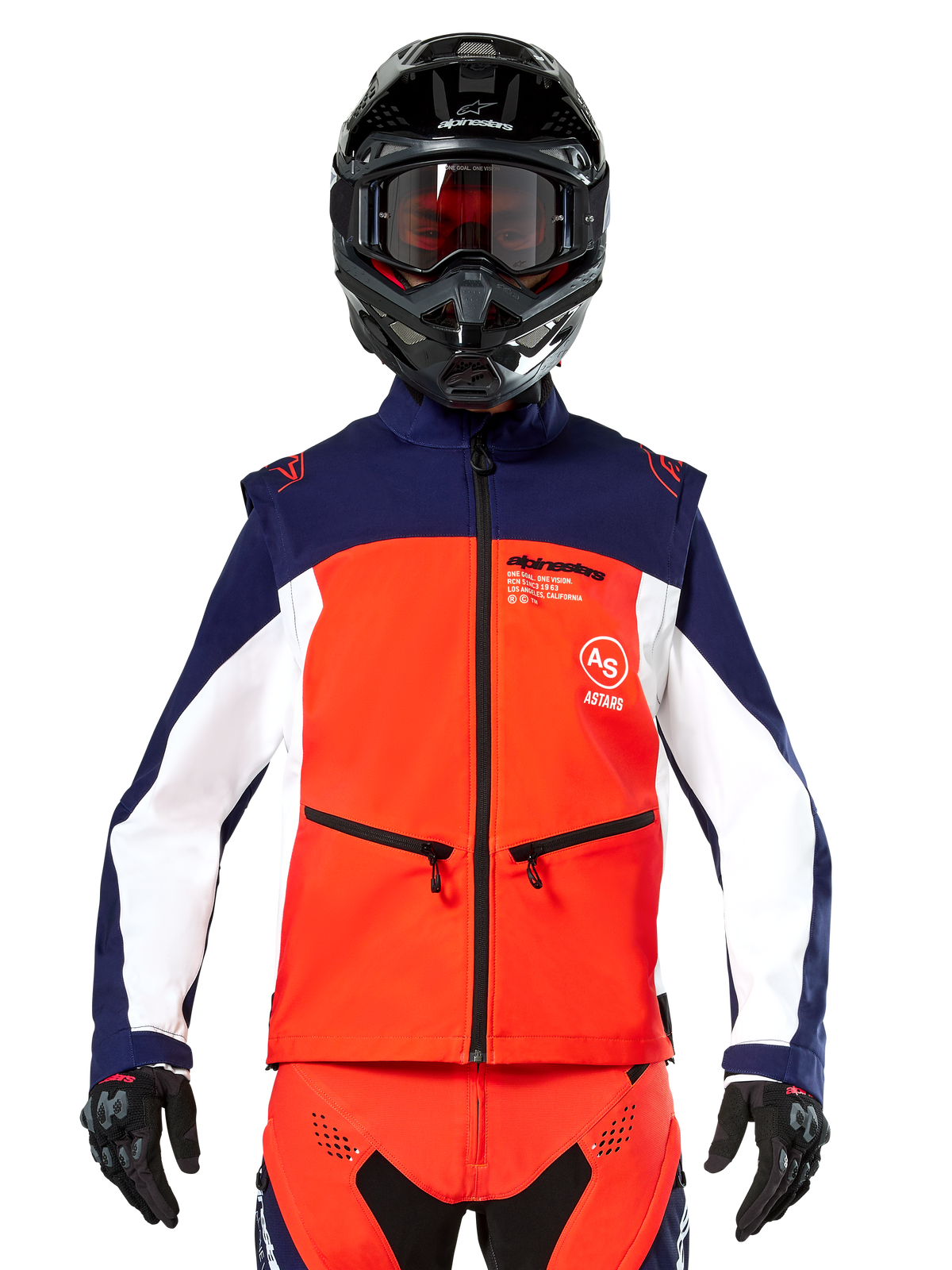 Casaco Alpinestars Lite-Dura Softshell em azul-marinho, laranja vibrante e branco, vista frontal num piloto com capacete preto e óculos, design técnico de blocos de cor, bolsos de mão com fecho e marca Alpinestars, equipamento versátil para enduro e condução off-road