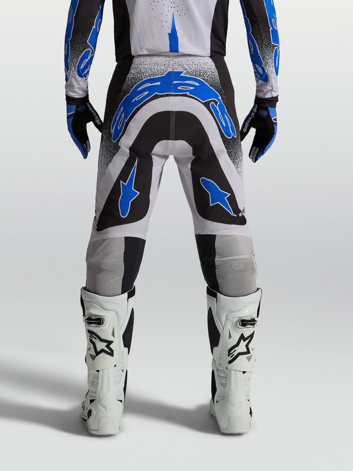 Calças Alpinestars Supertech Hiten AFD para motocross, pretas e azuis, vista traseira com ajuste atlético para off-road