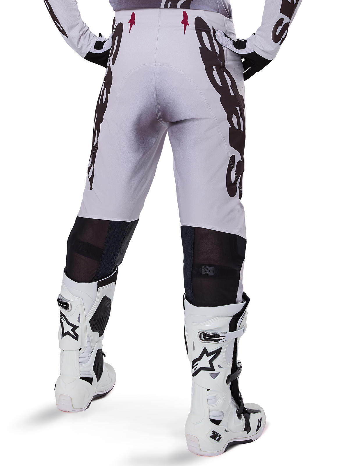 Alpinestars 2025 Supertech Maker Pants, Motocross Pants, Silver and Black, back view showing large black logos on thighs and breathable mesh zones behind the knees, worn with white Alpinestars boots.