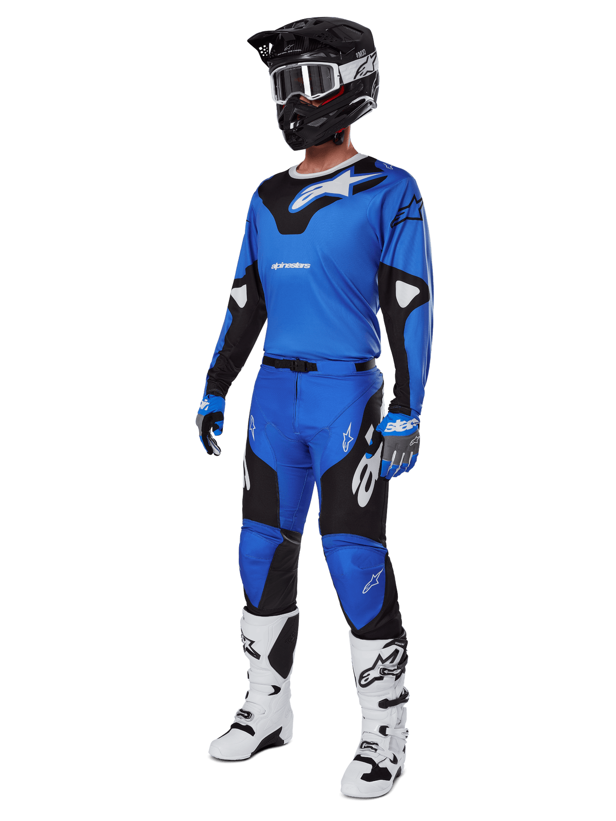 Piloto de motocross com equipamento completo de corrida, incluindo calças Alpinestars 2025 Racer Veil em azul e preto, camisola azul a condizer com detalhes brancos, capacete preto com óculos brancos, botas brancas e pretas e luvas azuis, conjunto coordenado para competições todo-o-terreno