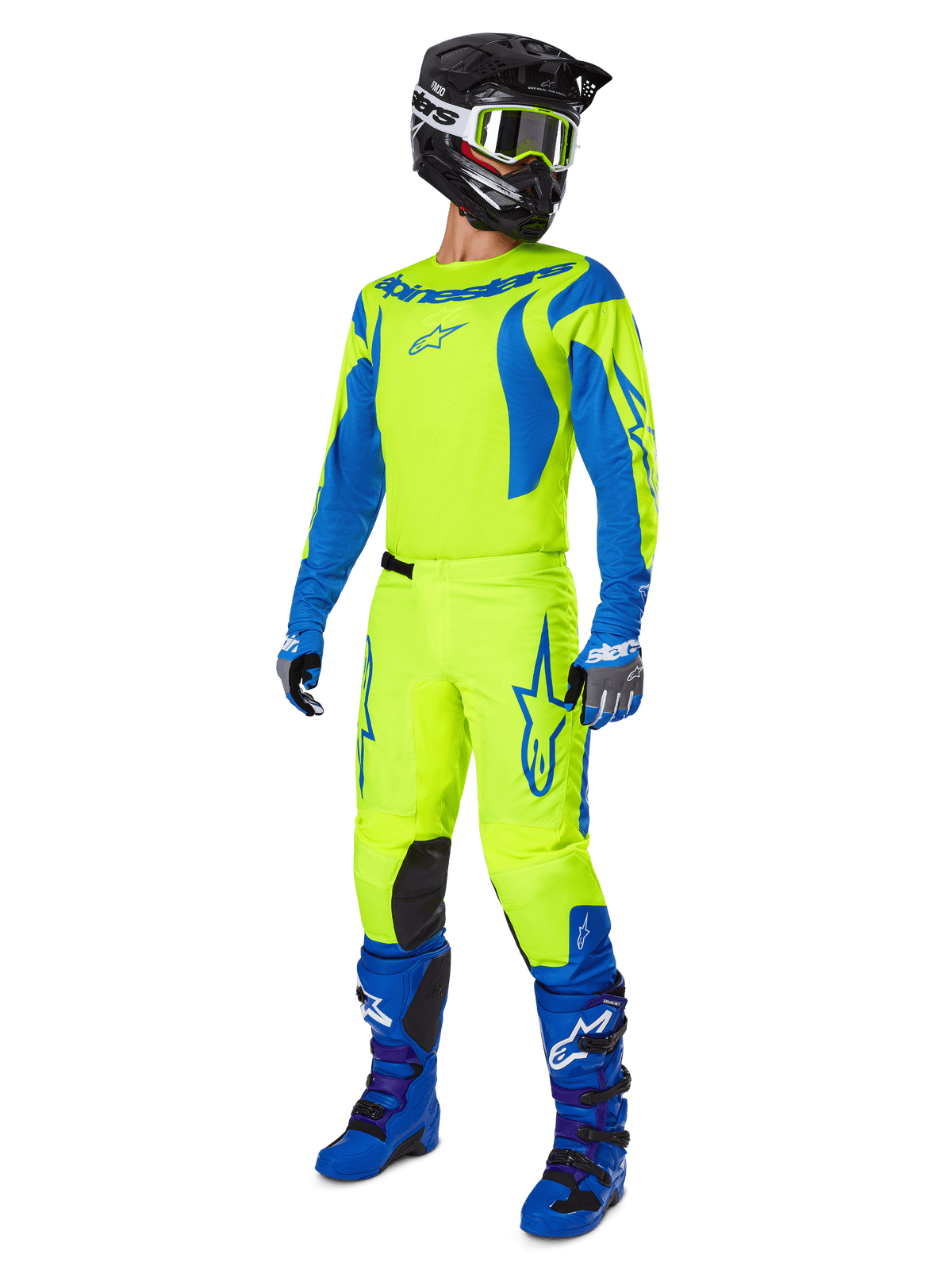 Alpinestars 2025 Fluid Haul Pants, calças de motocross, amarelo flúor e azul, vestidas como parte de um conjunto completo de equipamento de corrida com camisola a condizer, botas azuis e capacete preto, design de alta visibilidade para condução todo-o-terreno.