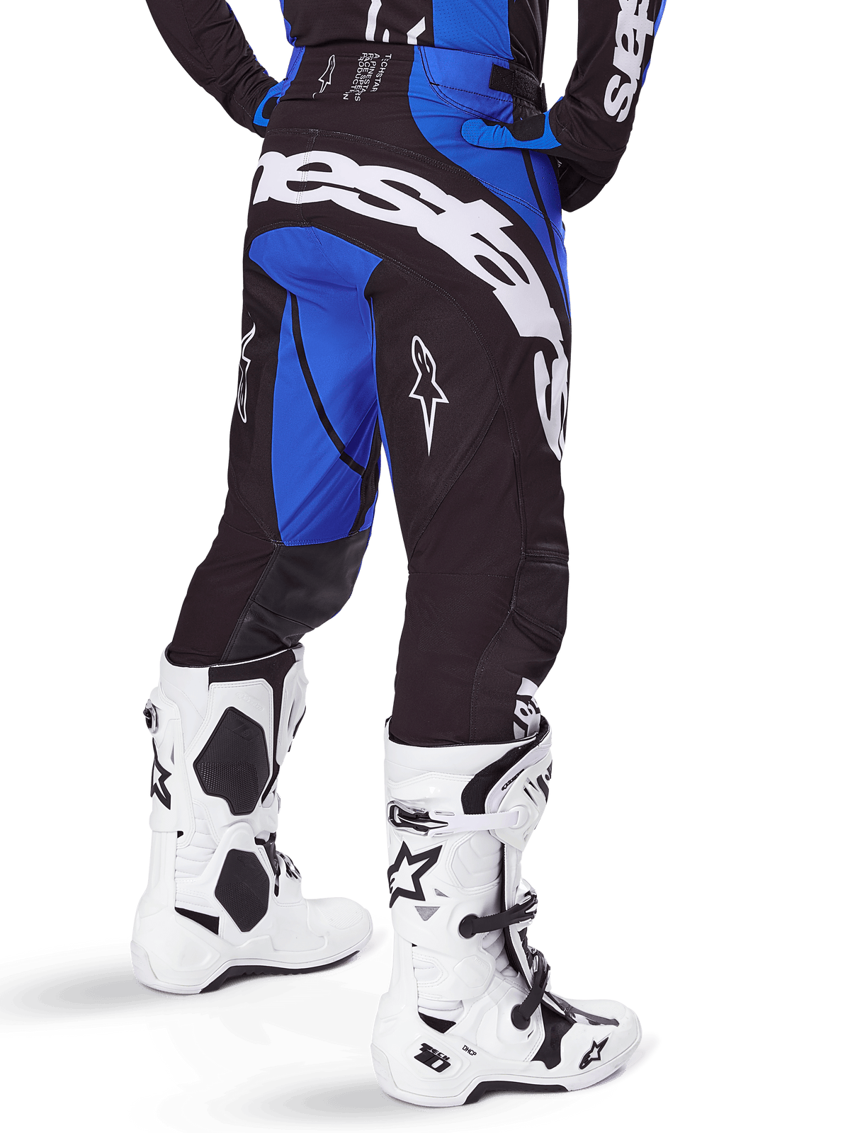 Alpinestars 2025 Techstar Dreem Pants, Motocross Pants, Black and Blue, rear view featuring bold white Alpinestars branding on the seat, worn with white and black motocross boots and matching blue jersey, athletic fit for off-road racing