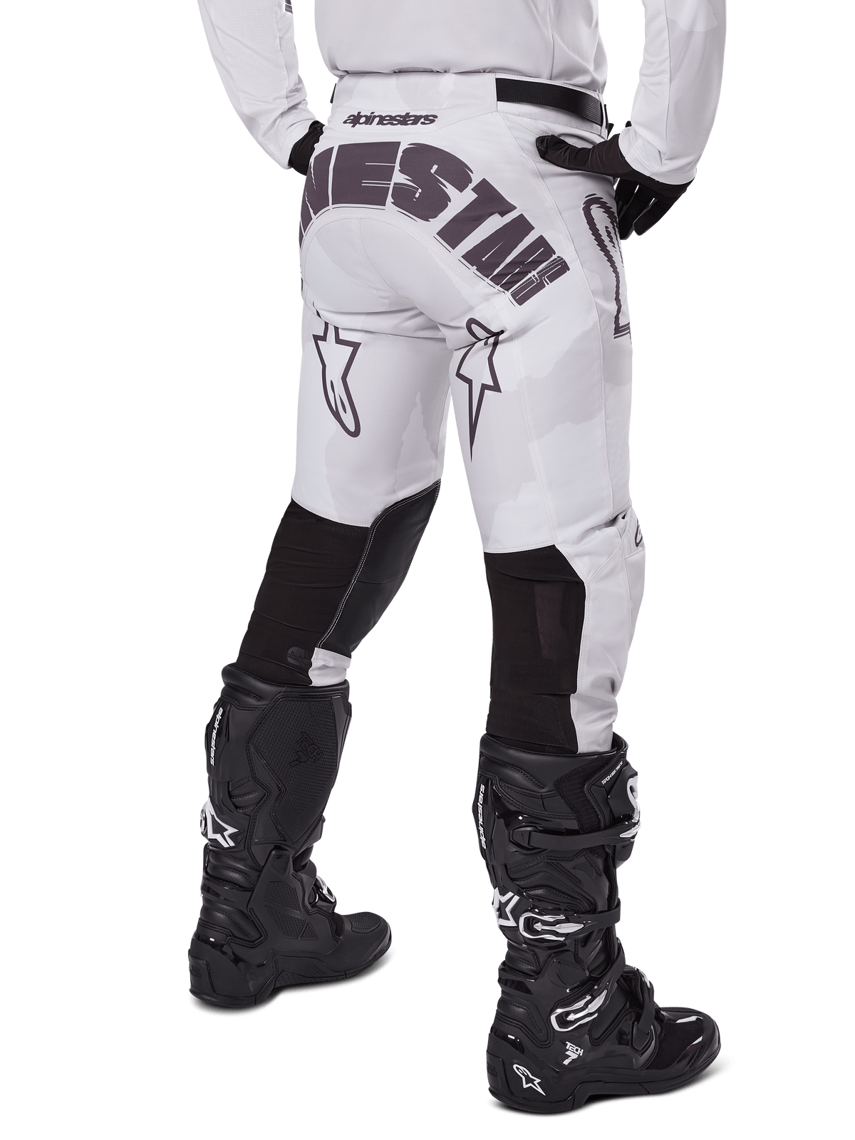 Alpinestars 2025 Racer Hollow Pants, Motocross Pants, Light Camo Brown, rear view of rider showing large branding on seat and black stretch panels on lower legs, paired with black Tech 7 boots