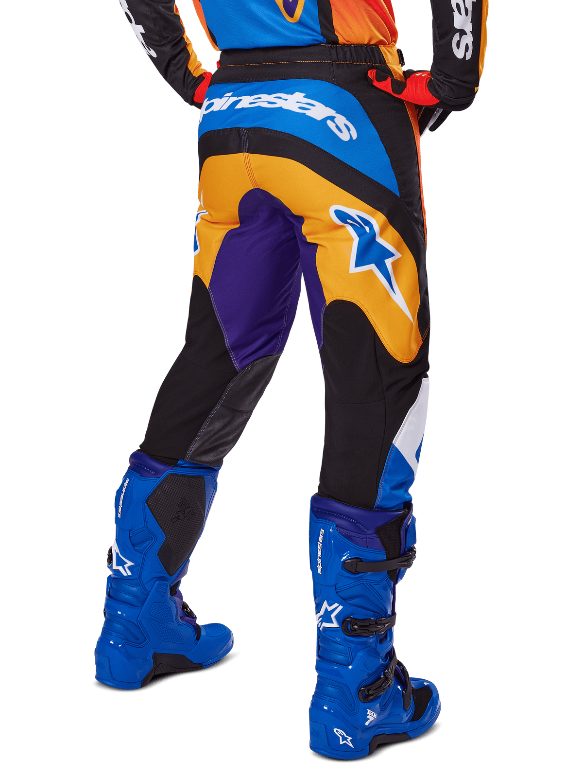 Alpinestars 2025 Fluid Wurx Pants, Motocross Pants, Multicolor with Orange, Purple, and Blue, rear view showing white Alpinestars logo on the back, paired with blue motocross boots, athletic fit for off-road racing.