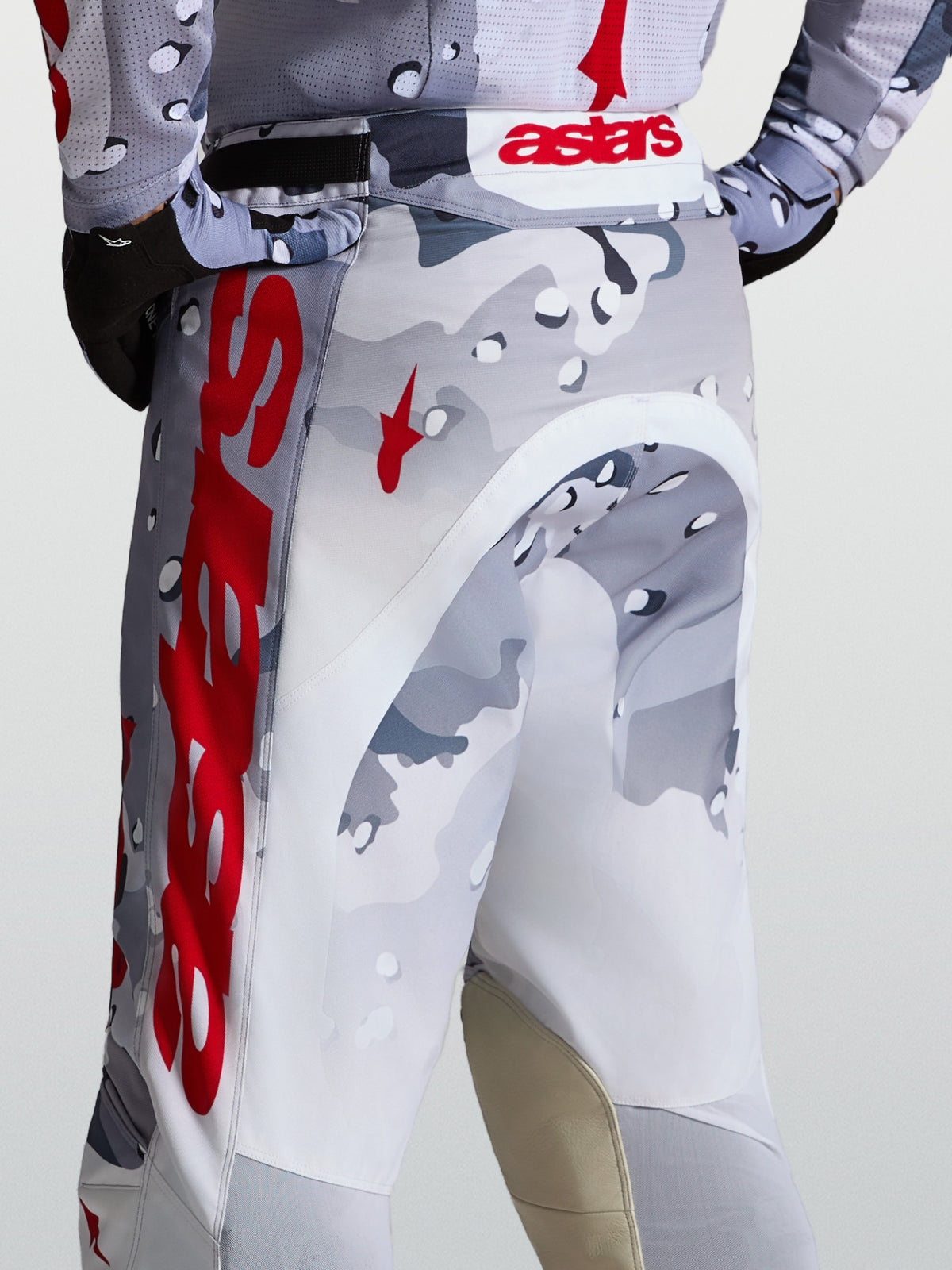 Alpinestars Racer Air Lone Pants for motocross, featuring gray camo and red perforated polyfabric construction.