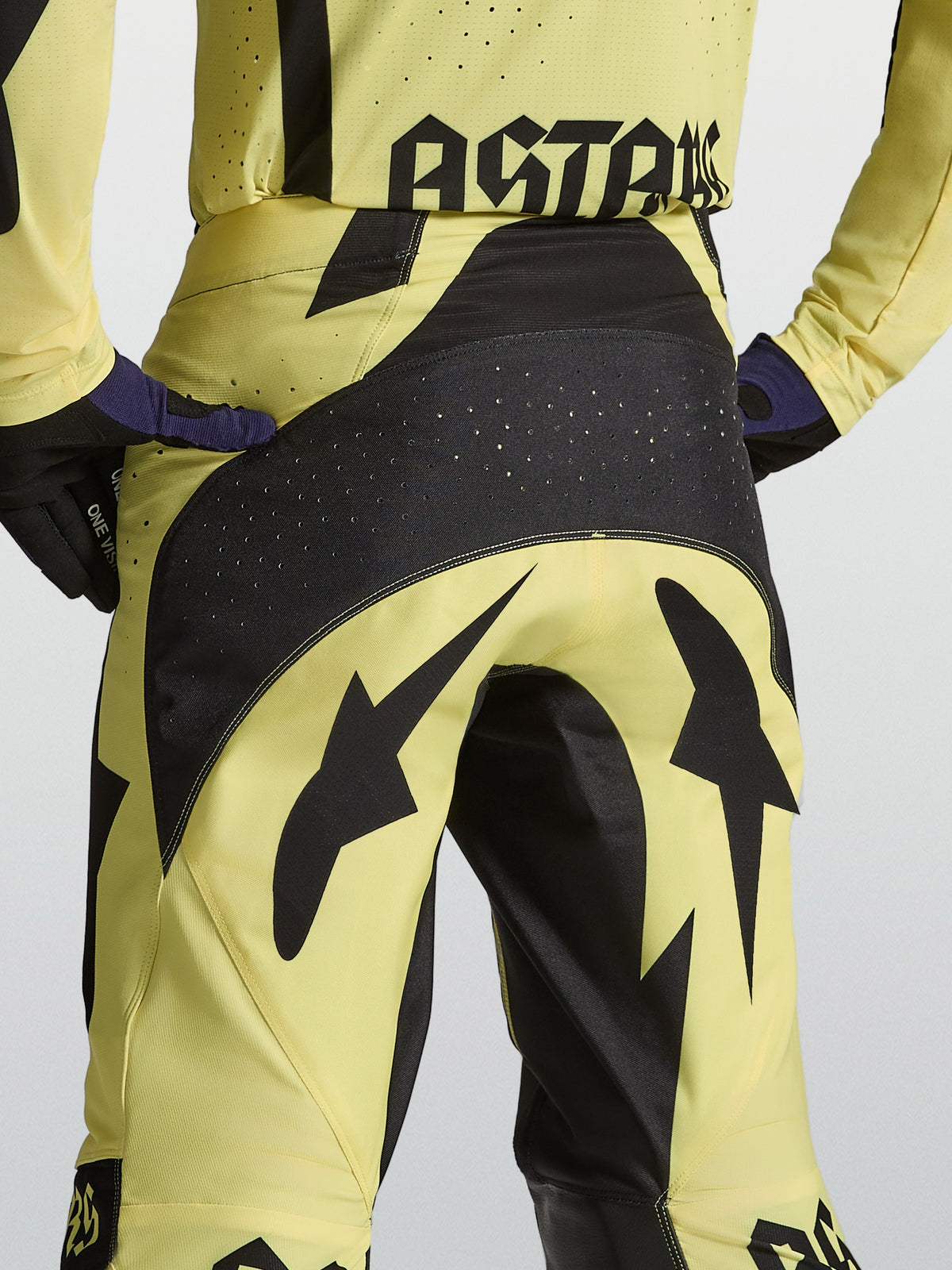 Alpinestars Techstar Atrox motocross pants, yellow and black, featuring a reinforced perforated seat and athletic racing fit.