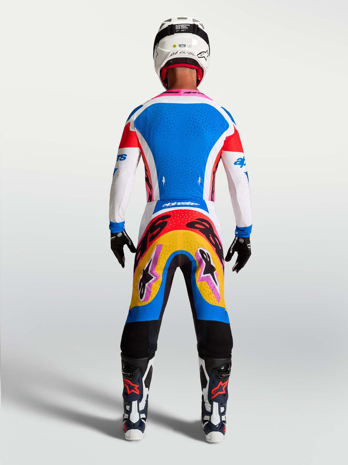 Alpinestars Supertech Dyna Jersey and Gear Set, blue and white motocross kit, rear view on-model with pink accents.
