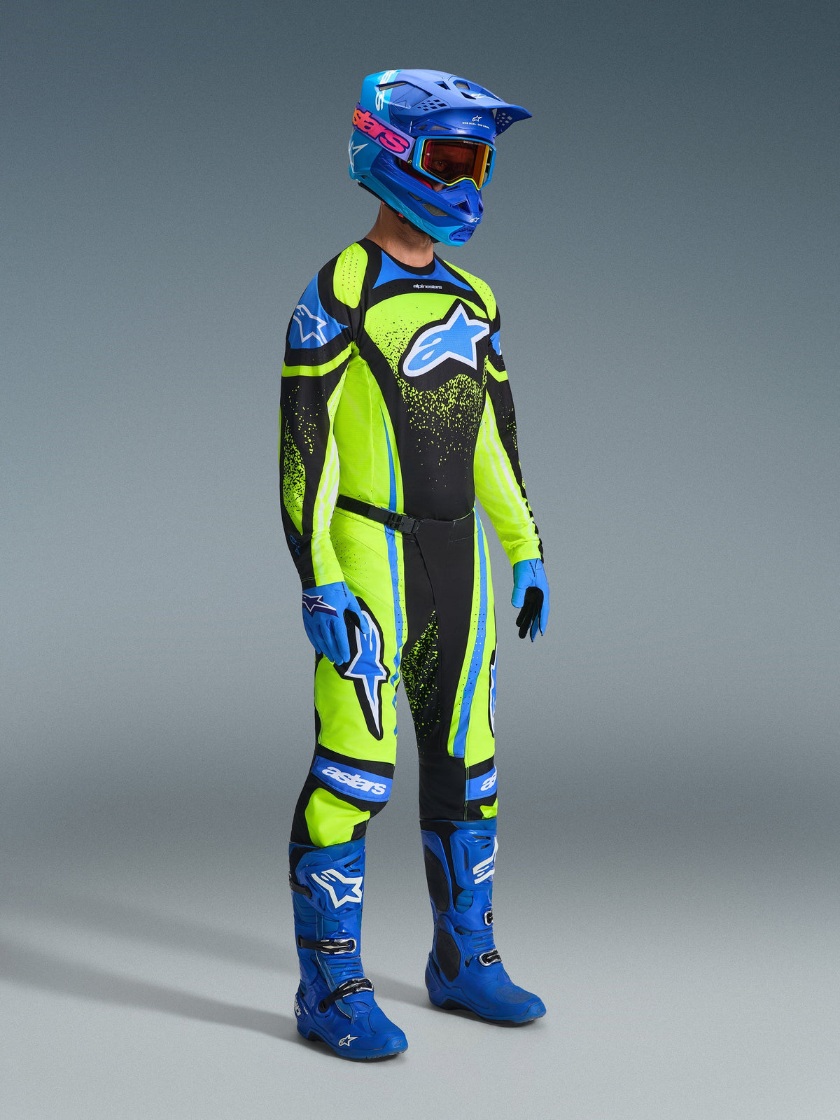 Piloto de motocross com equipamento de corrida completo, Camisola Techstar Nomur 2026 em Azul Marinho e Amarelo Fluo, calças a condizer, capacete azul com óculos, botas e luvas azuis, conjunto coordenado para corridas de todo-o-terreno