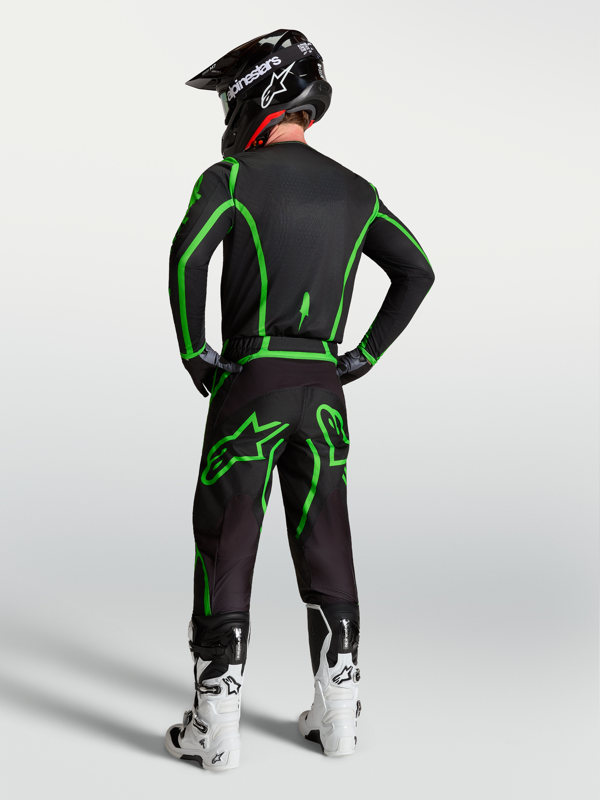 Alpinestars Calças Fluid Apex V2, calças de motocross para homem, pretas e verde fluo, vista traseira em conjunto completo.