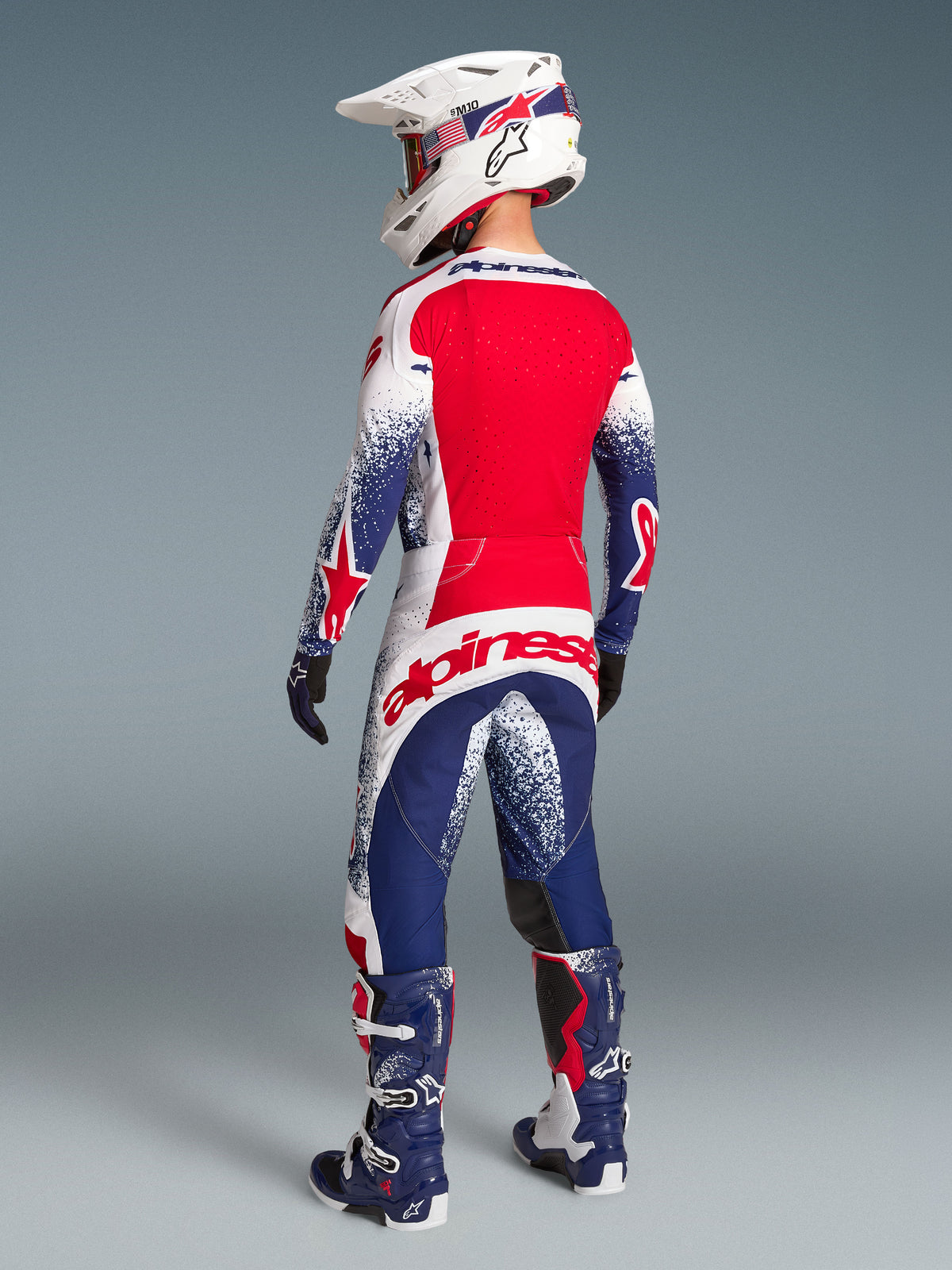 Alpinestars Techstar Unity Jersey edição limitada, camisola de motocross vermelha, branca e azul, vista traseira ventilada.