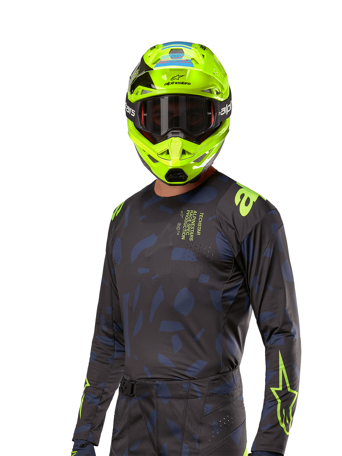Camisola Alpinestars 2024 Techstar Rantera, camisola de competição de motocross, preto e azul-marinho com padrões abstratos e detalhes em amarelo néon, usada com um capacete amarelo néon a condizer, design de corte de performance para condução todo-o-terreno