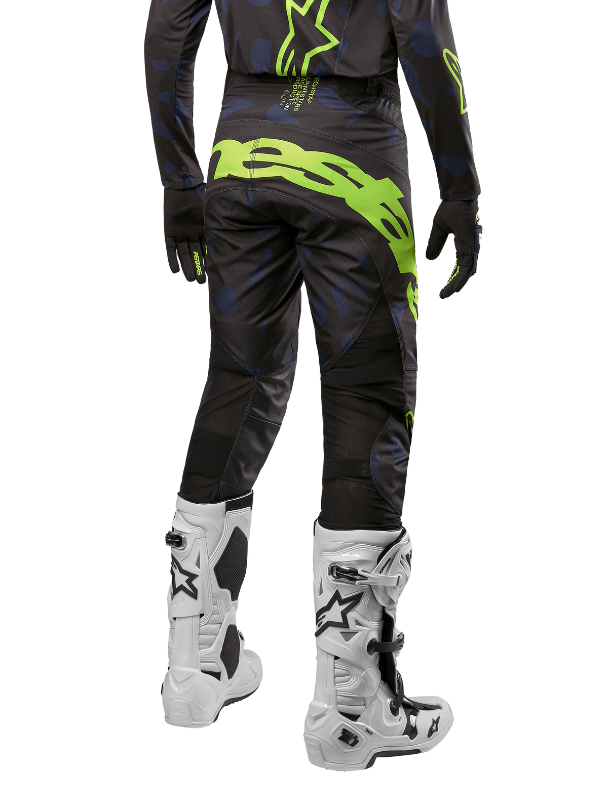 Alpinestars 2024 Techstar Rantera Pants, calças de motocross, preto, azul-marinho e amarelo fluo, vista traseira, com logótipo amarelo néon de destaque e painéis de ventilação em malha, usadas com camisola a condizer e botas brancas, equipamento durável para motocross e corridas todo-o-terreno