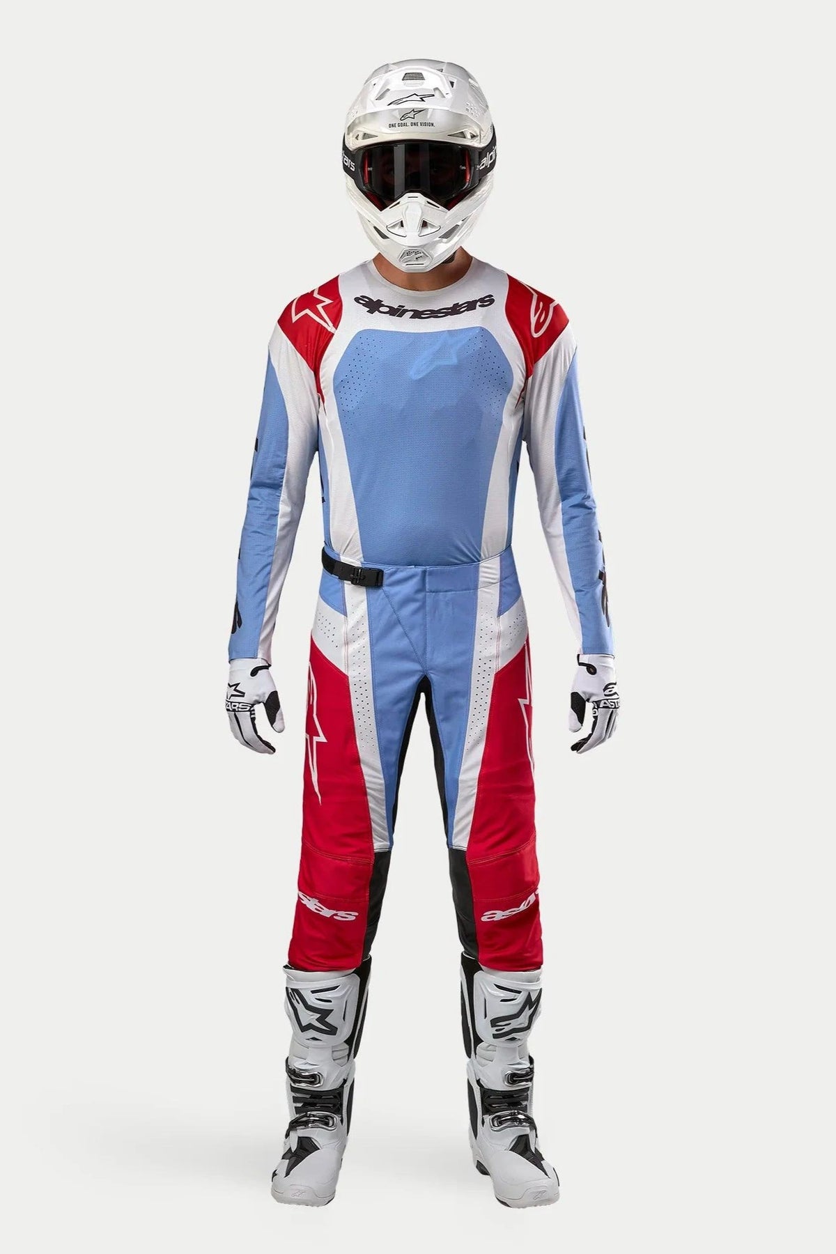 Motocross rider wearing the complete 2024 Alpinestars Techstar Ocuri kit, Light Blue Mars Red and White jersey and pants, paired with a white helmet, white boots, and gloves, professional racing gear for off-road motocross