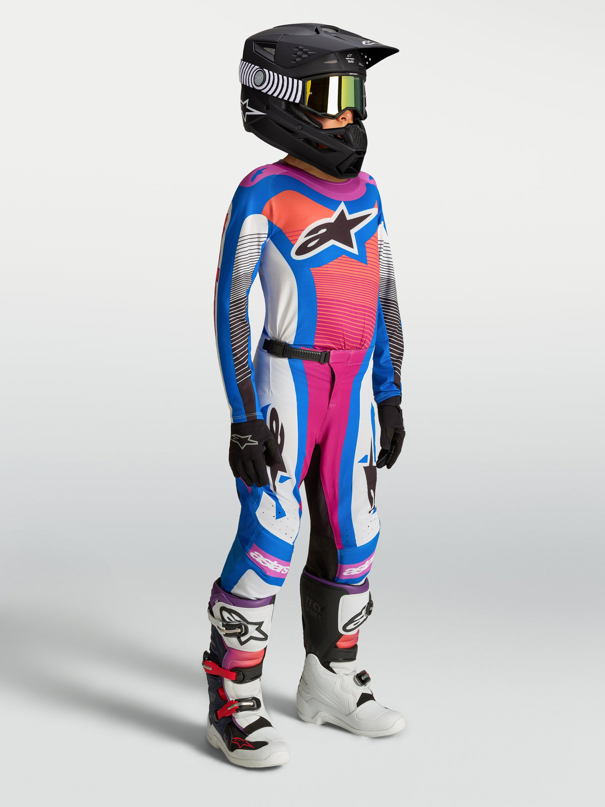 Alpinestars Juventude Supertech Maven 2027, camisola e conjunto de motocross azul e coral em malha elástica.