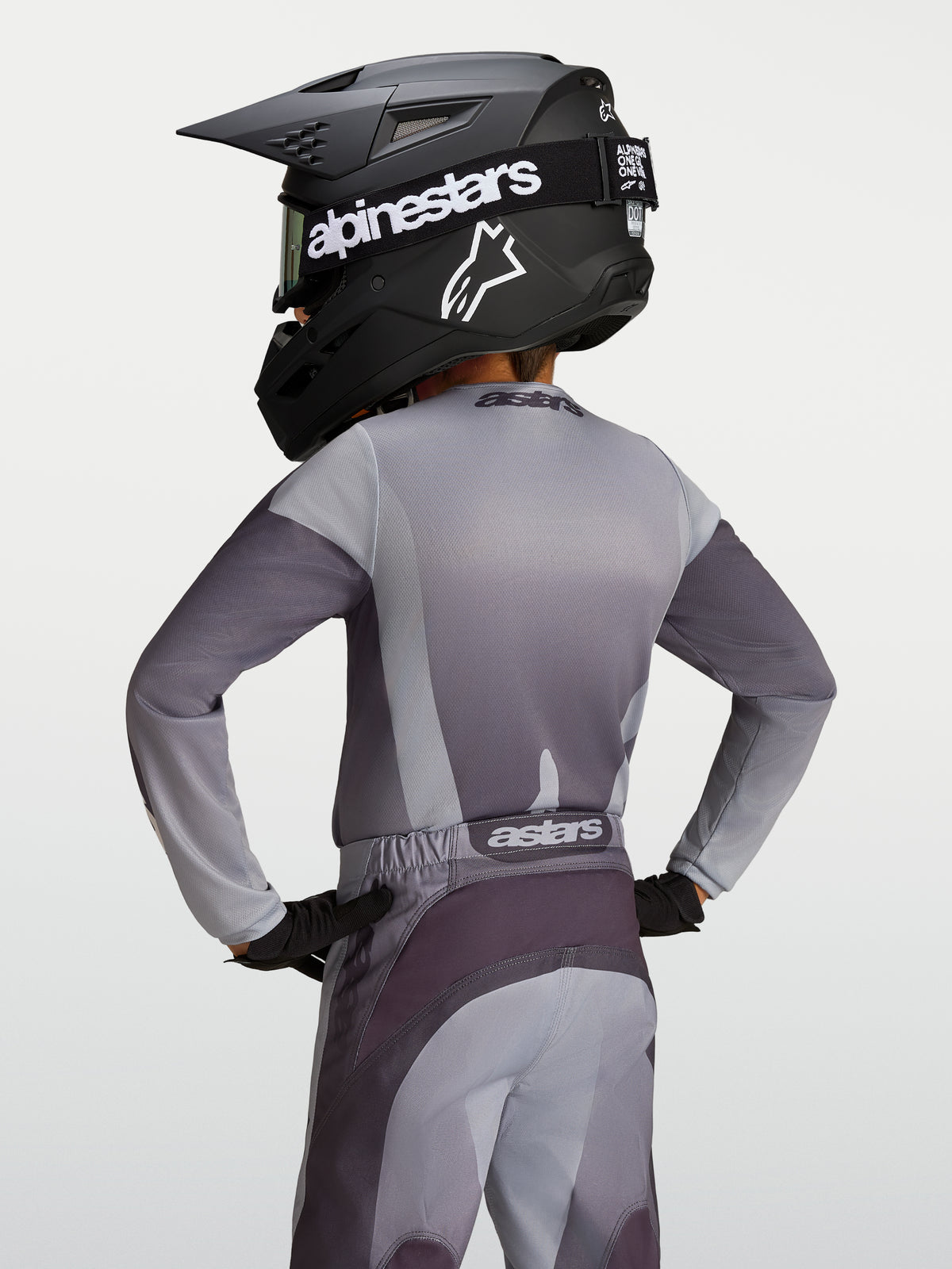 Alpinestars Youth Fluid Amber Jersey, gray and sand moisture-wicking motocross jersey on a young rider, back view.