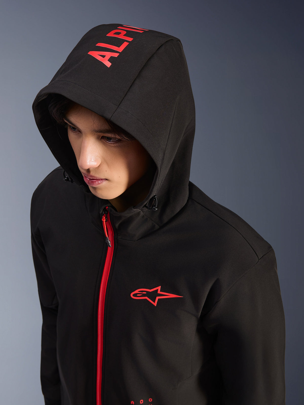 Alpinestars Radium Tech Hoodie, Black and Bright Red, urban technical shell motorcycle hoodie, red Alpinestars logo on chest and red branding on the hood, bright red zipper, modern motorsport-inspired streetwear