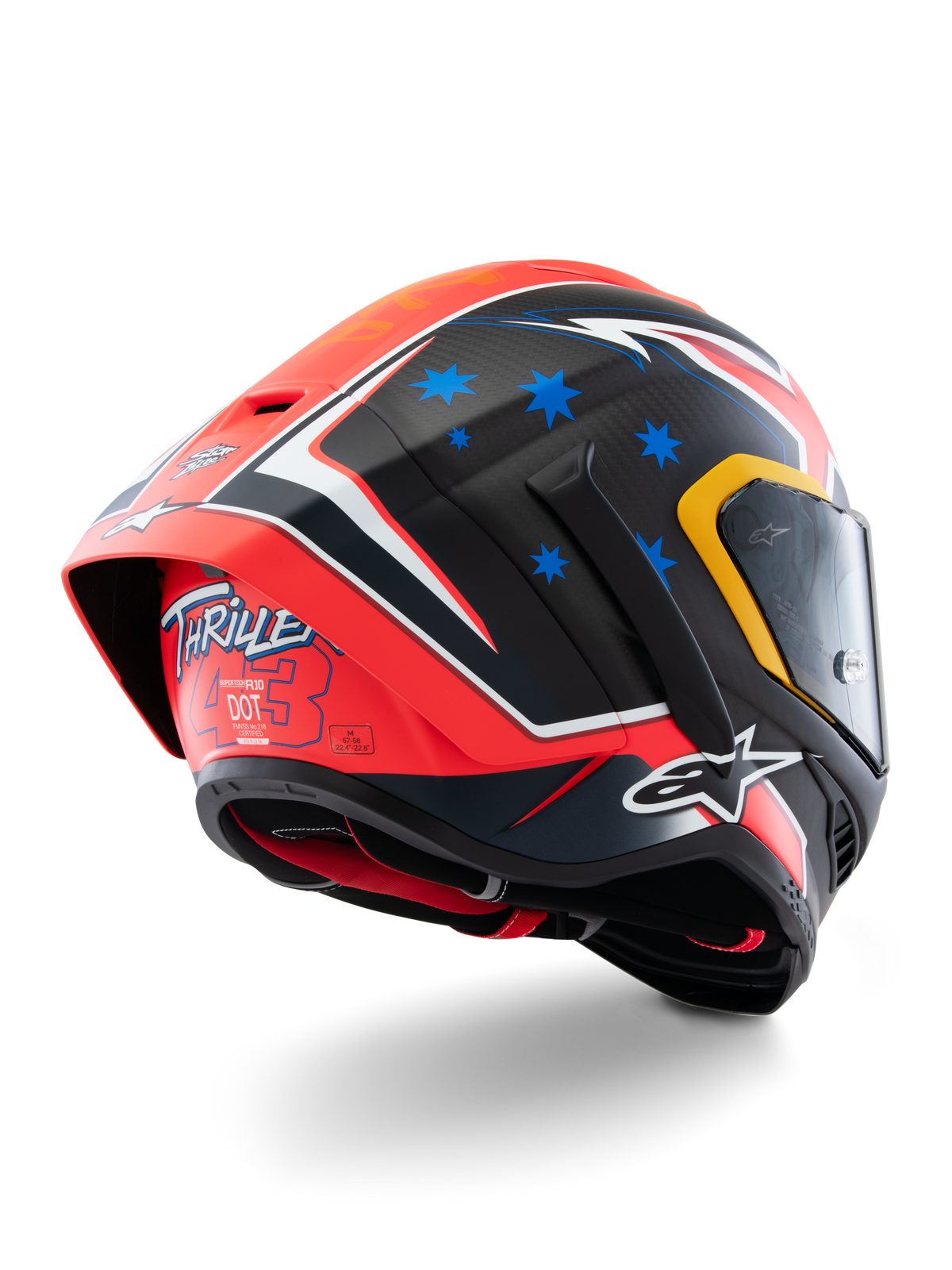Capacete Alpinestars Supertech R10 Miller Limited Edition, capacete de corrida integral, Carbon Red Matt com estrelas azuis e detalhes brancos, grafismo 'Thriller 43' na parte traseira, spoiler aerodinâmico de grandes dimensões, construção em fibra de carbono