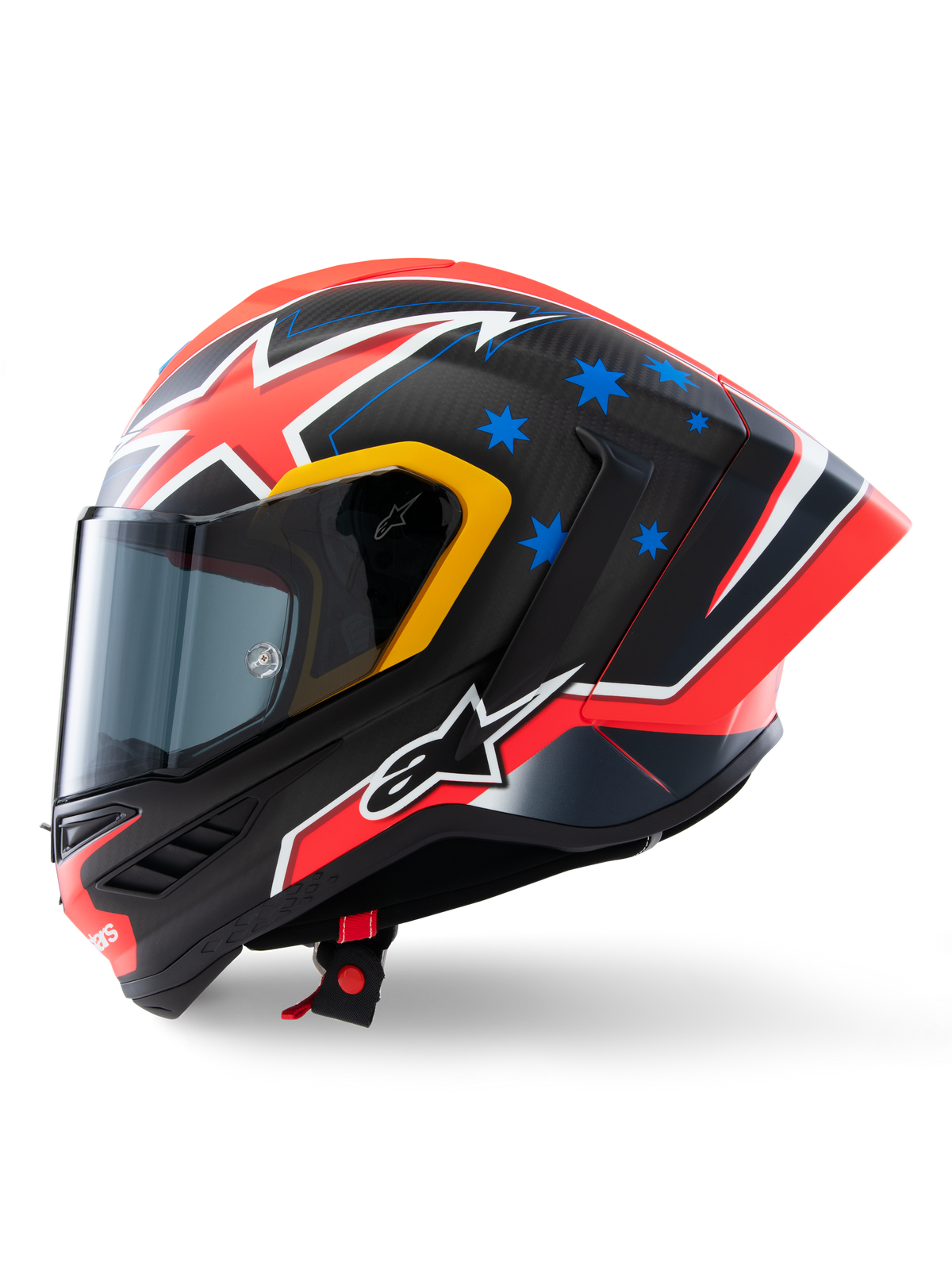 Capacete Alpinestars Supertech R10 Miller Limited Edition, perfil lateral, acabamento Carbon Red Matt com trama de fibra de carbono visível, grafismos de relâmpagos vermelhos e brancos, estrelas azuis na parte traseira, pormenores amarelos em torno da viseira e logótipo Alpinestars branco, capacete de motociclismo de competição de alta performance