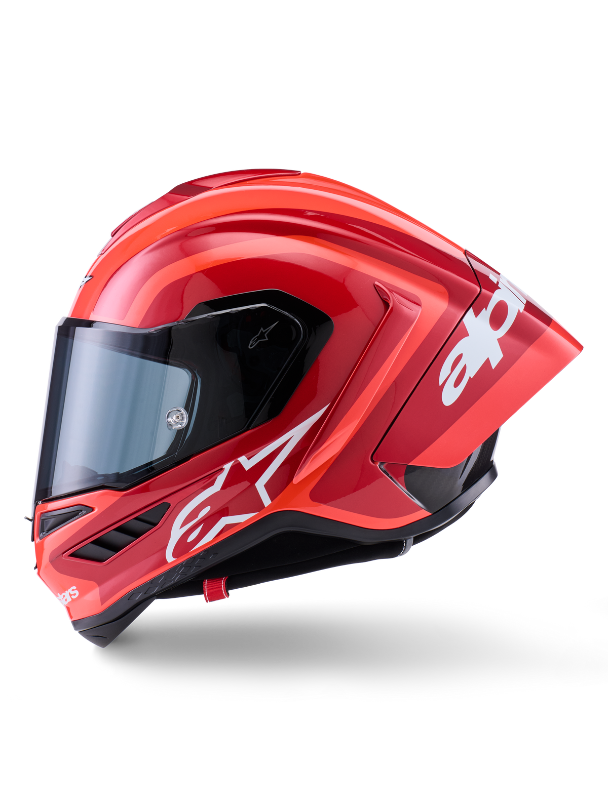 Capacete Alpinestars Supertech R10 Arius, capacete de corrida integral, vermelho brilhante com grafismos de logótipo brancos, vista de perfil lateral destacando o spoiler aerodinâmico e a viseira transparente, calota em composto de fibra de carbono para motociclismo profissional