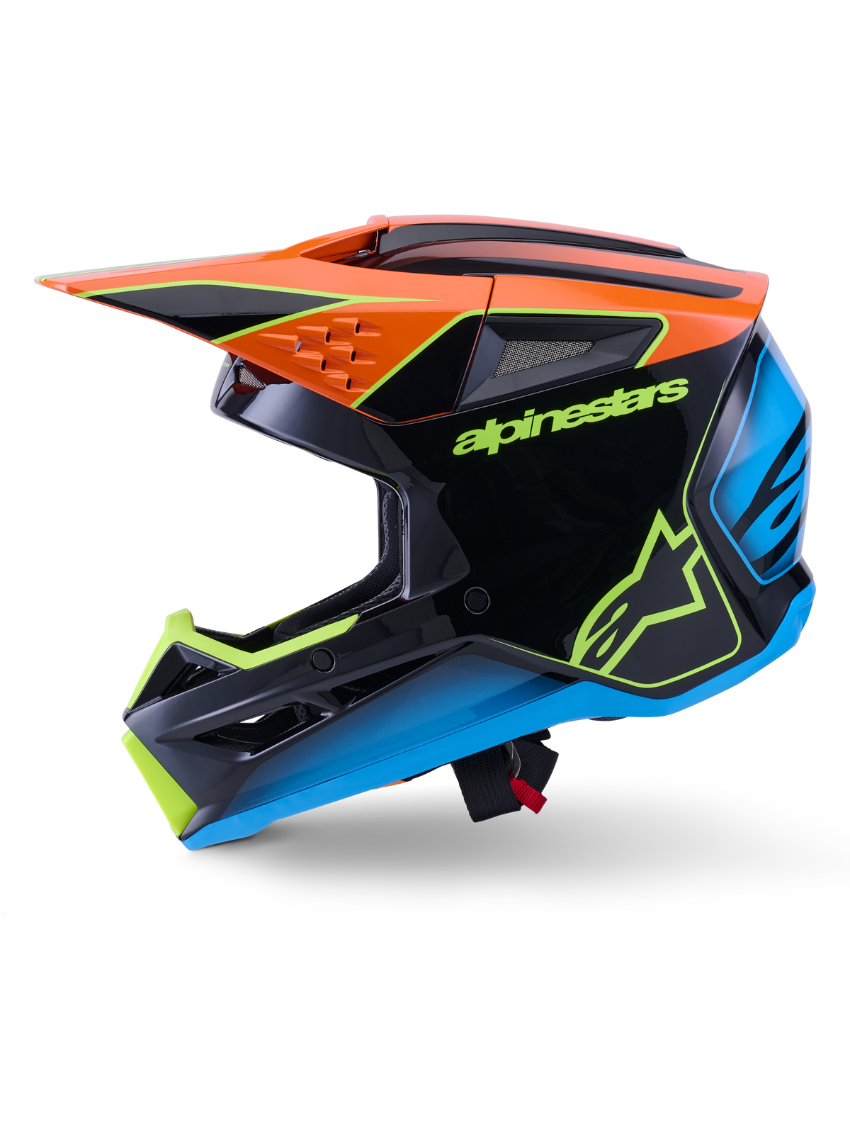 Capacete Alpinestars S-M3 Fray ECE 22.06, capacete de motocross, preto com detalhes em cor de laranja, azul e amarelo fluorescente, vista de perfil lateral exibindo a calote aerodinâmica e aberturas de ventilação integradas, com logótipos Alpinestars em destaque, proteção profissional para corridas todo-o-terreno