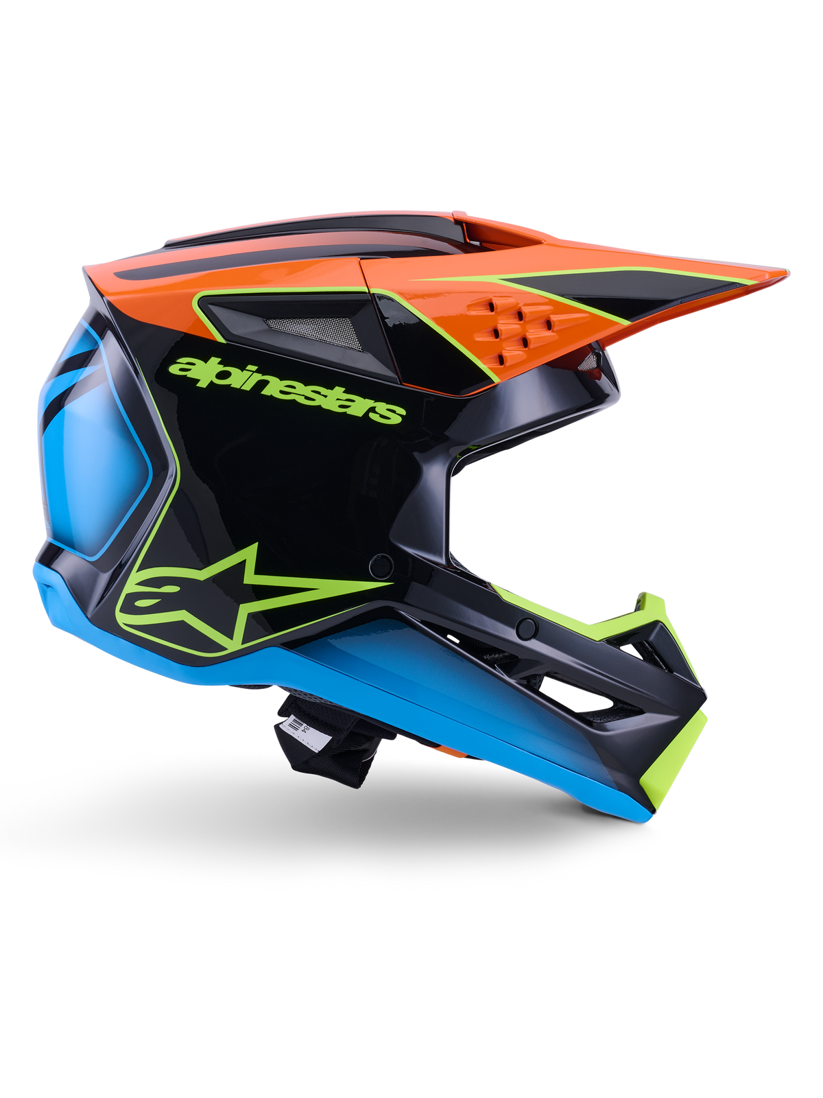 Capacete Alpinestars S-M3 Fray ECE 22.06, capacete de motocross, preto, laranja, azul e amarelo néon, perfil lateral de uma calota aerodinâmica brilhante com uma pala laranja proeminente, logótipo em verde néon e detalhes em azul, proteção para competição todo-o-terreno