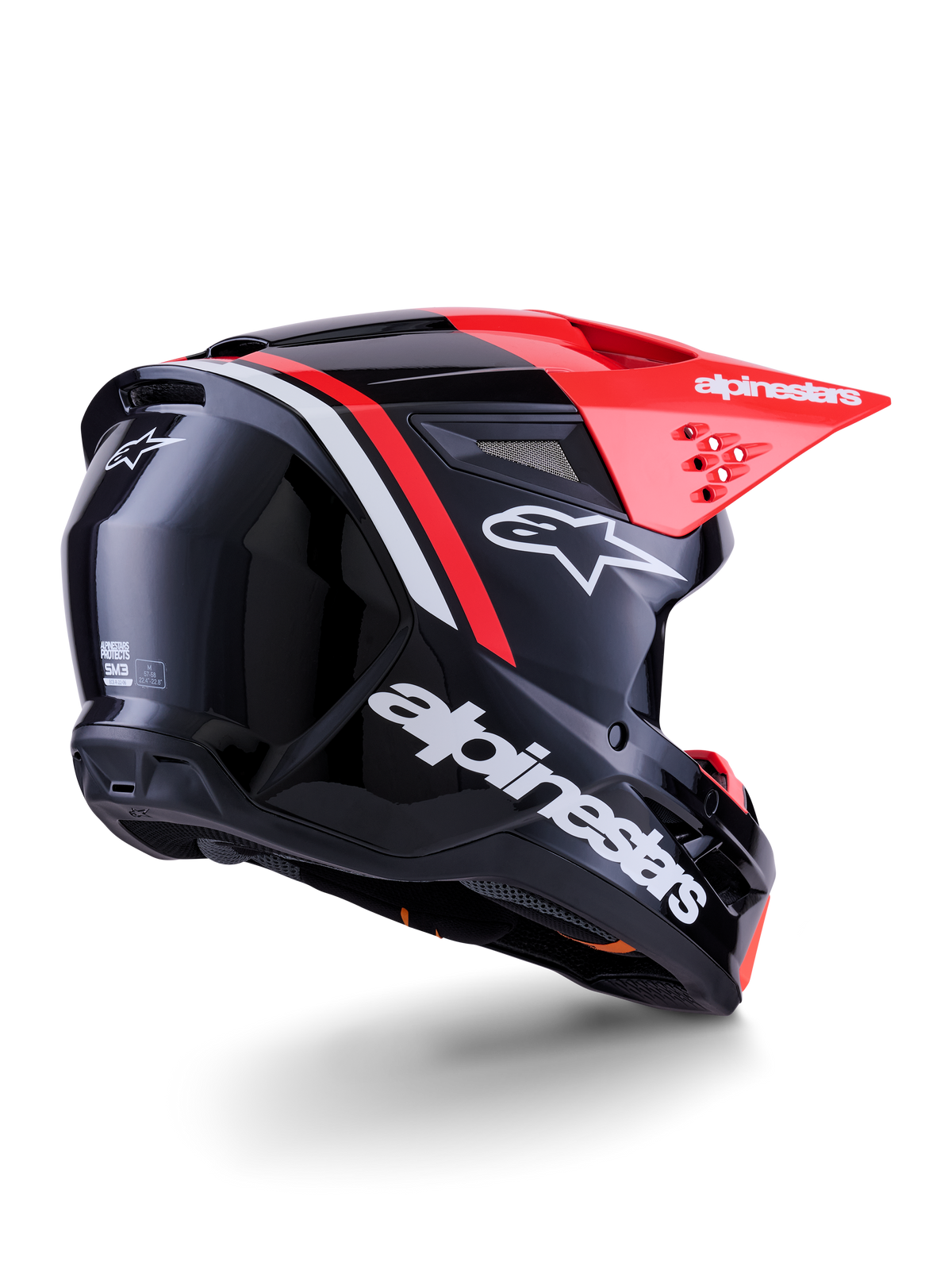Capacete Alpinestars S-M3 Radium, capacete de motocross, preto, vermelho fluo e branco brilhante, vista traseira de três quartos mostrando design aerodinâmico elegante, logótipos brancos e viseira vermelha brilhante, equipamento de proteção de alta performance para todo-o-terreno
